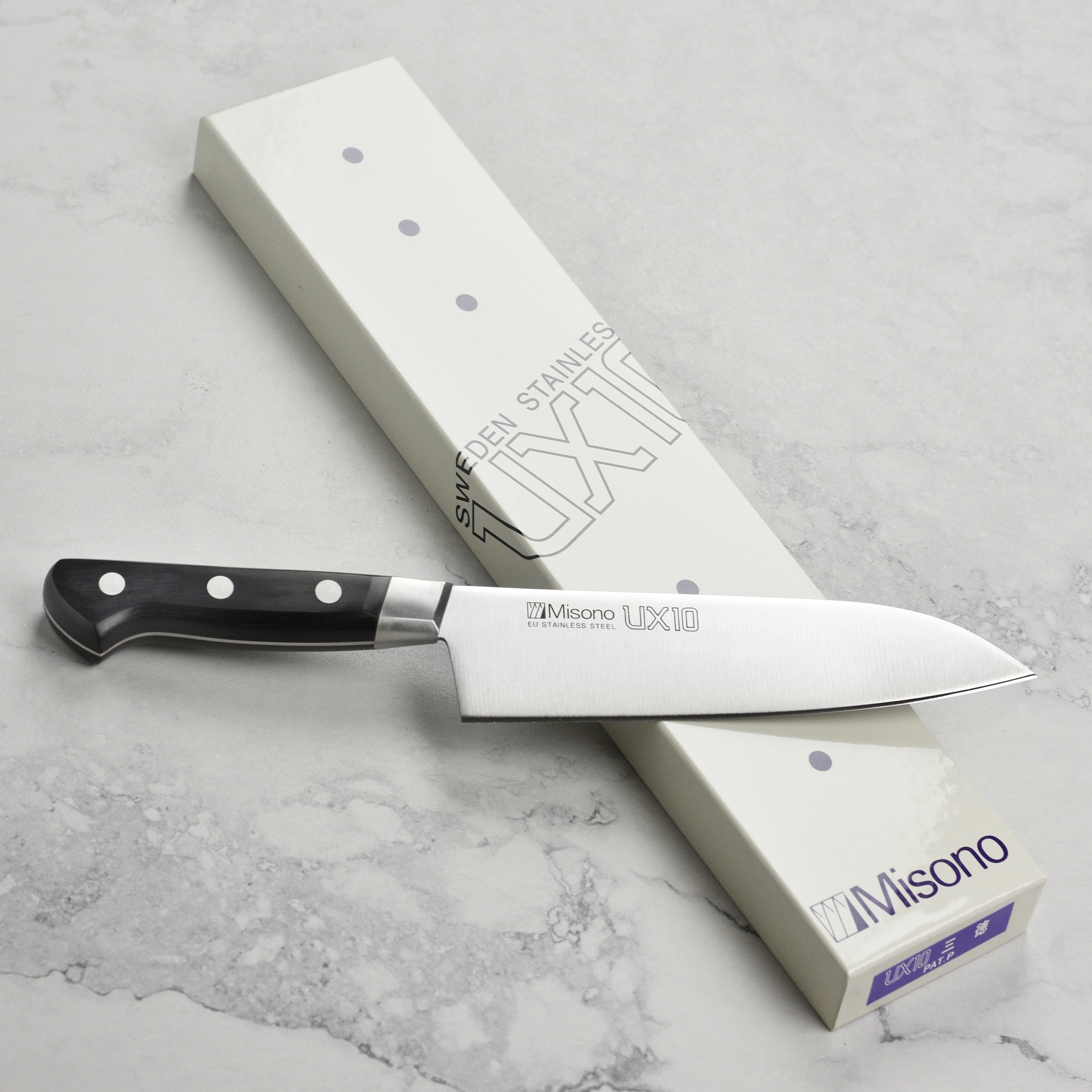 Misono UX10 Santoku knife showing the hand-forged blade and laminated black wood handle from a side angle.