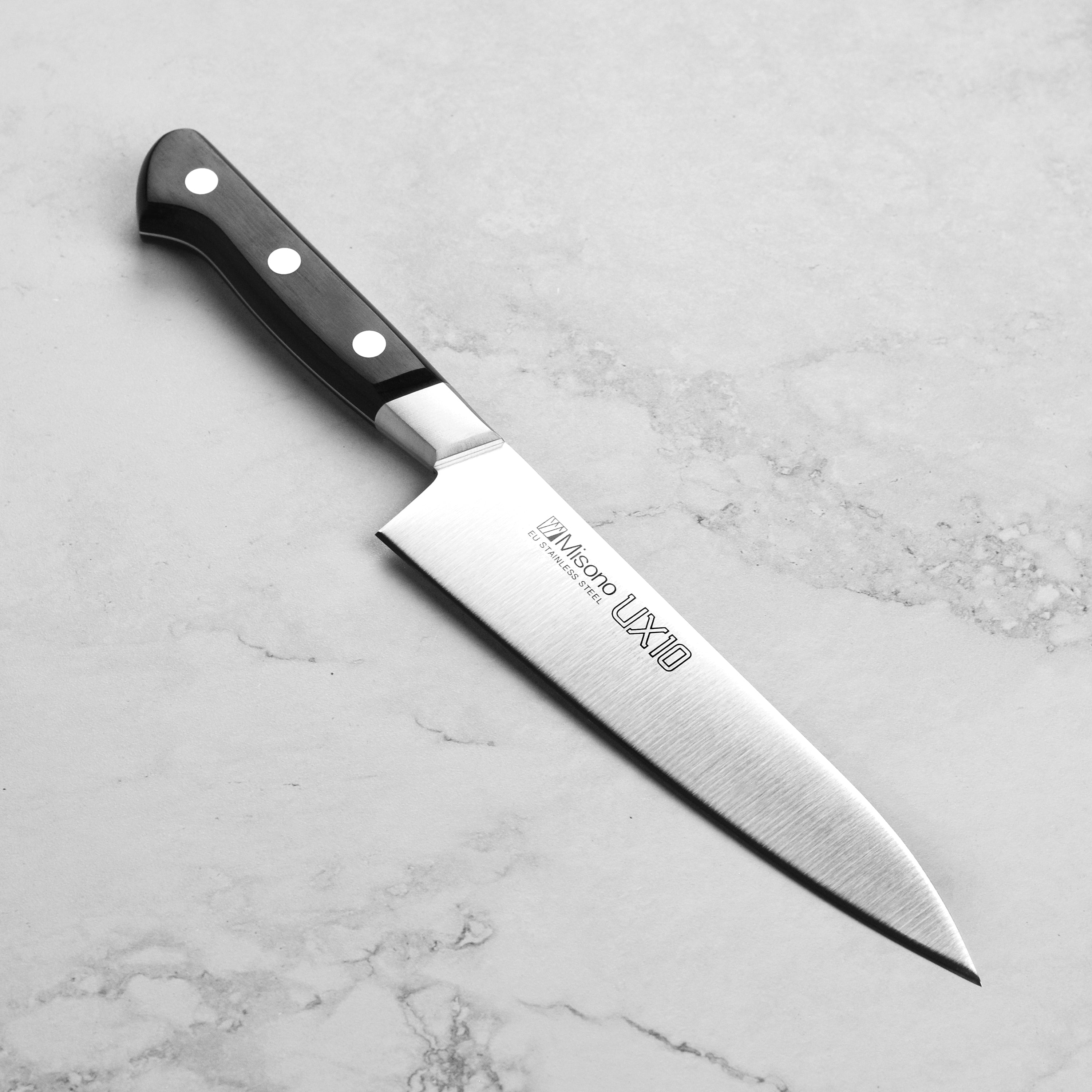 Close-up view of the Misono UX10 knife's blade and handle, emphasizing its elegant design.