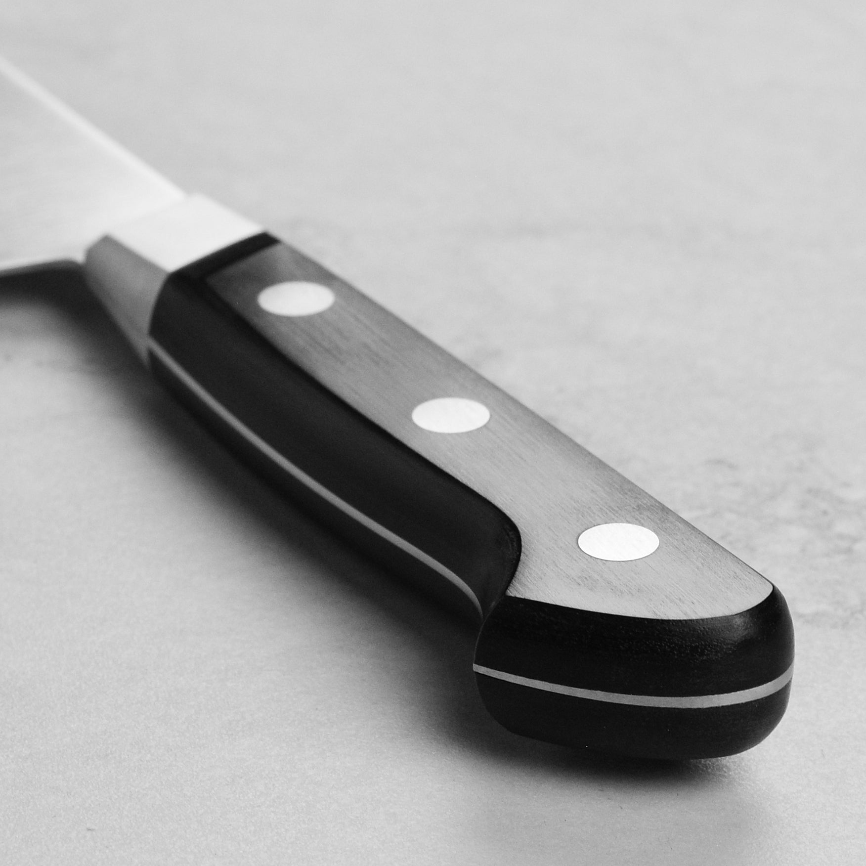 Misono UX10 gyuto knife in action, slicing through fresh vegetables with precision.