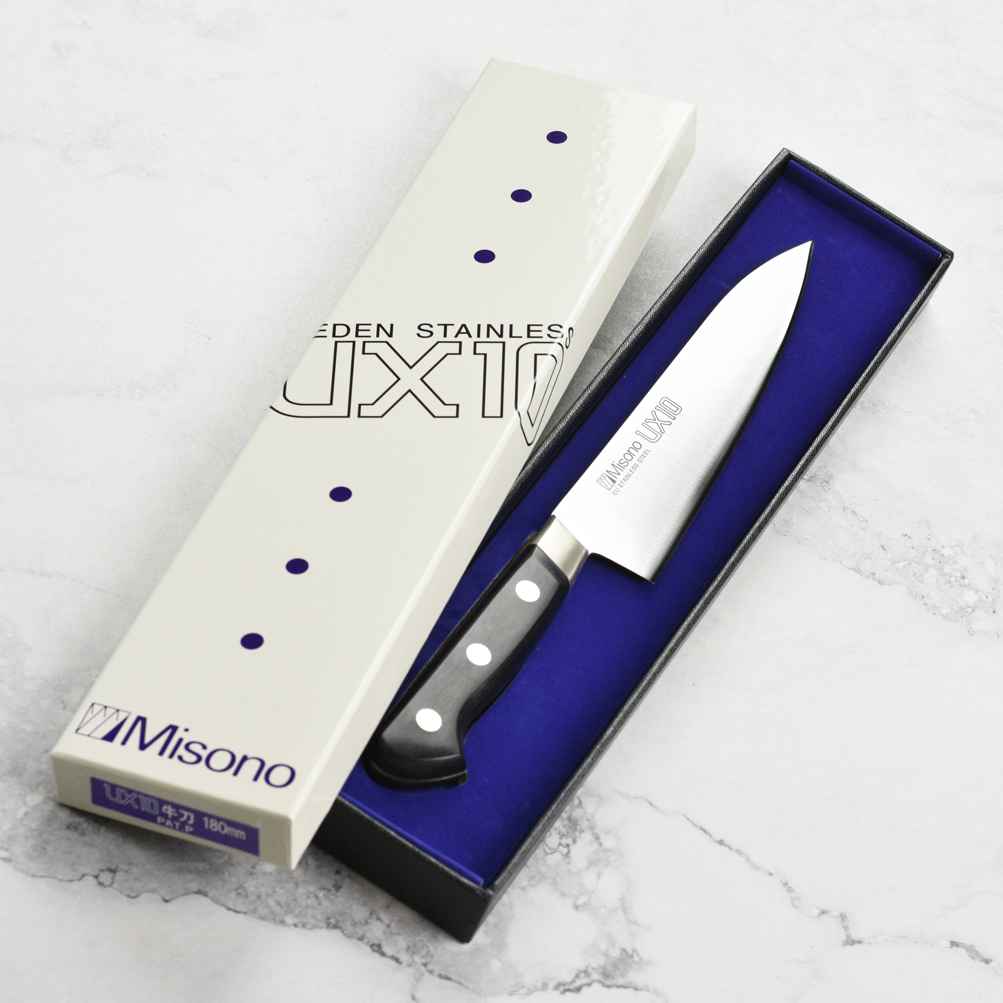 Close-up view of the Misono UX10 knifes blade and handle, emphasizing its elegant design.