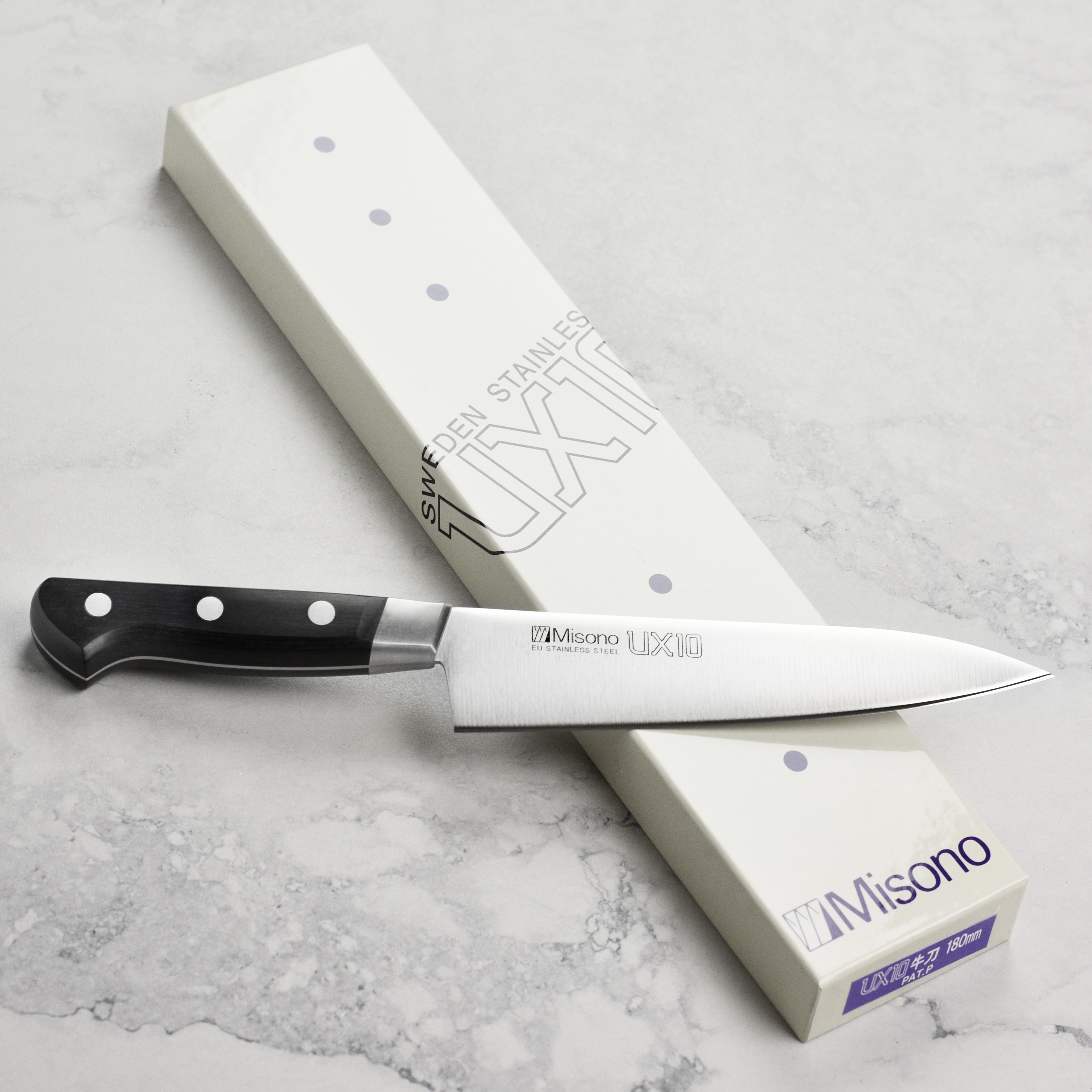 Close-up view of the Misono UX10 knifes blade and handle, emphasizing its elegant design.