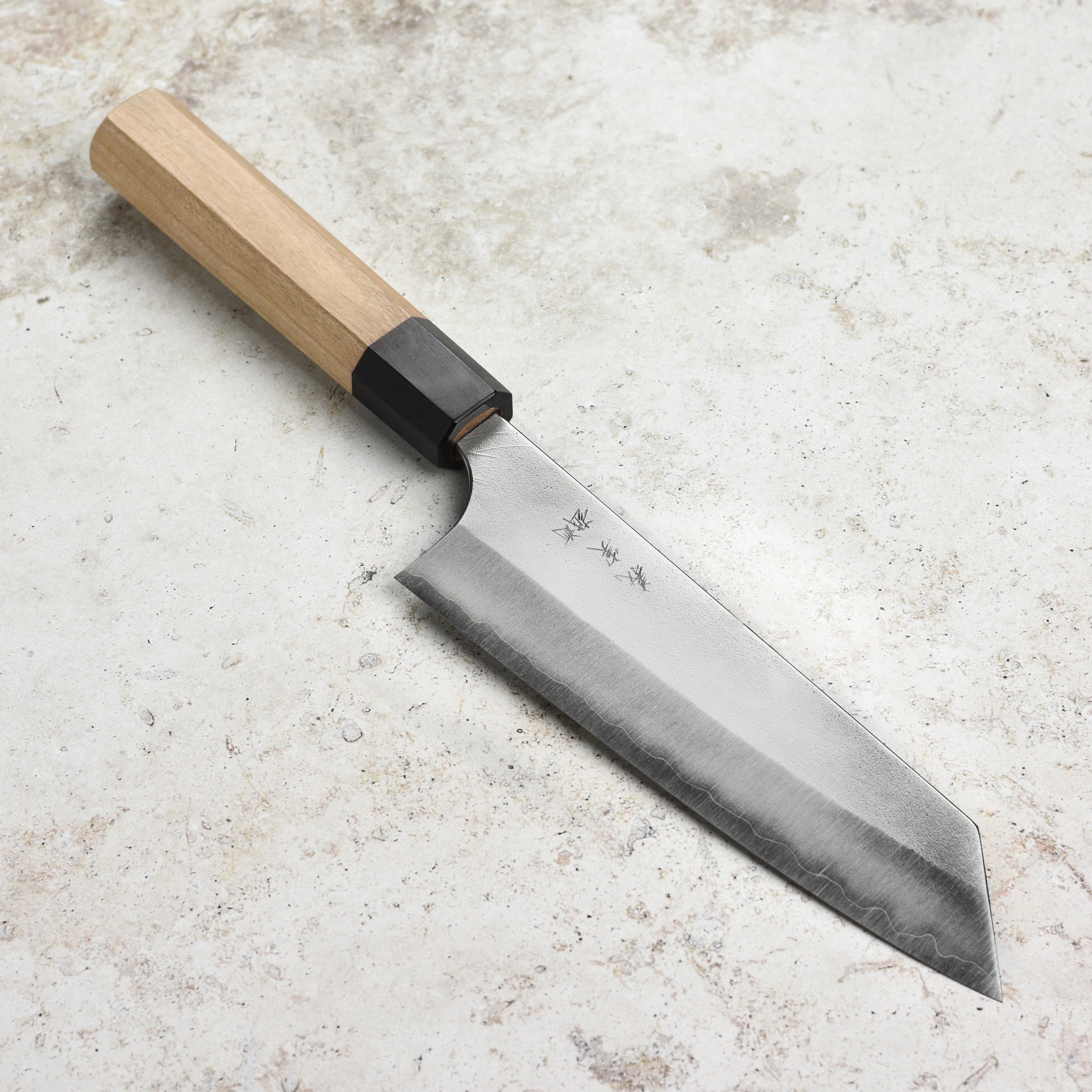 Close-up of the Aogami Super Nashiji Bunka knife showcasing its sharp blade and elegant design.