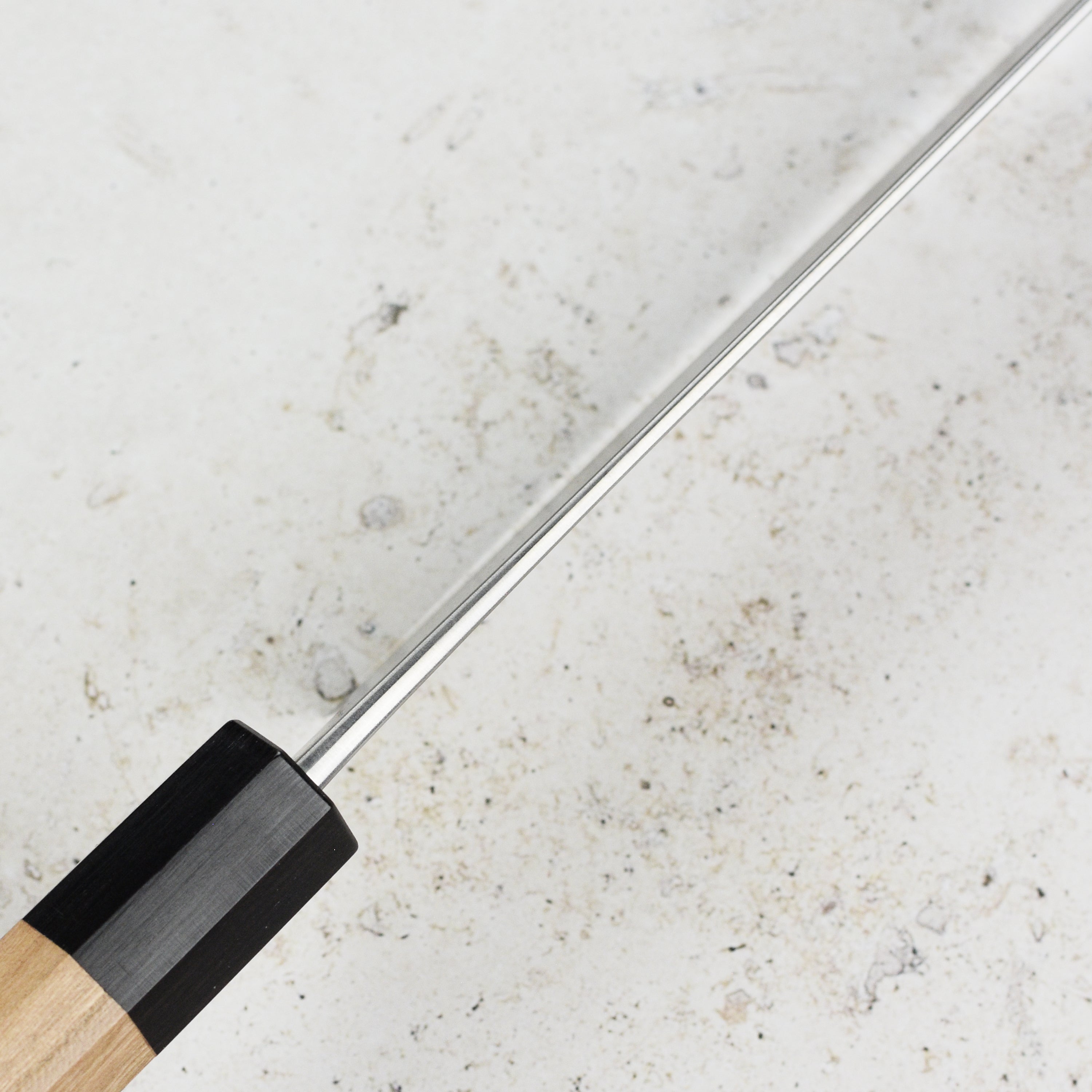 The Aogami Super Nashiji Bunka knife displayed with fresh ingredients, highlighting its versatility in the kitchen.