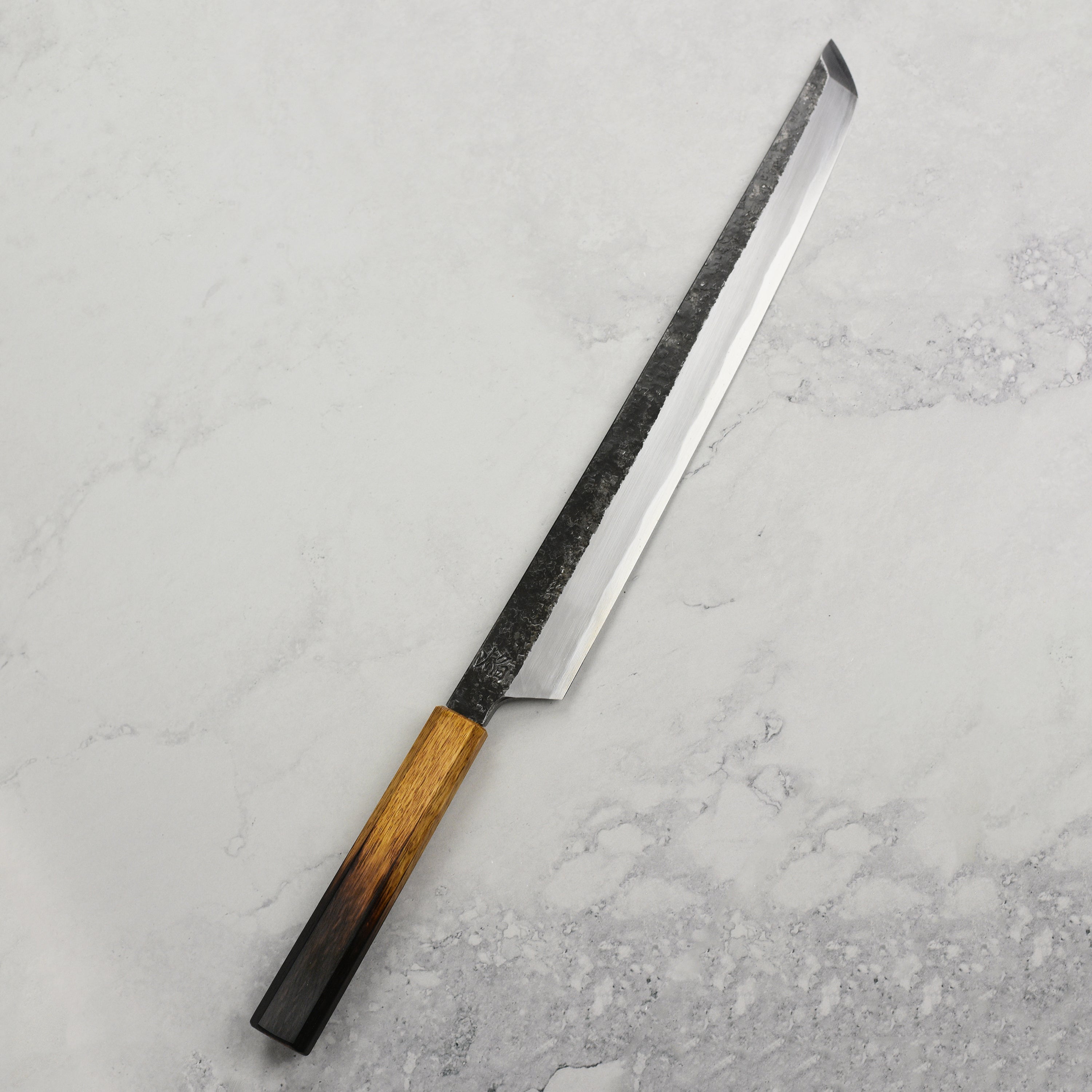 Close-up of the Takayuki sashimi knife highlighting the Aogami steel craftsmanship and single bevel edge.