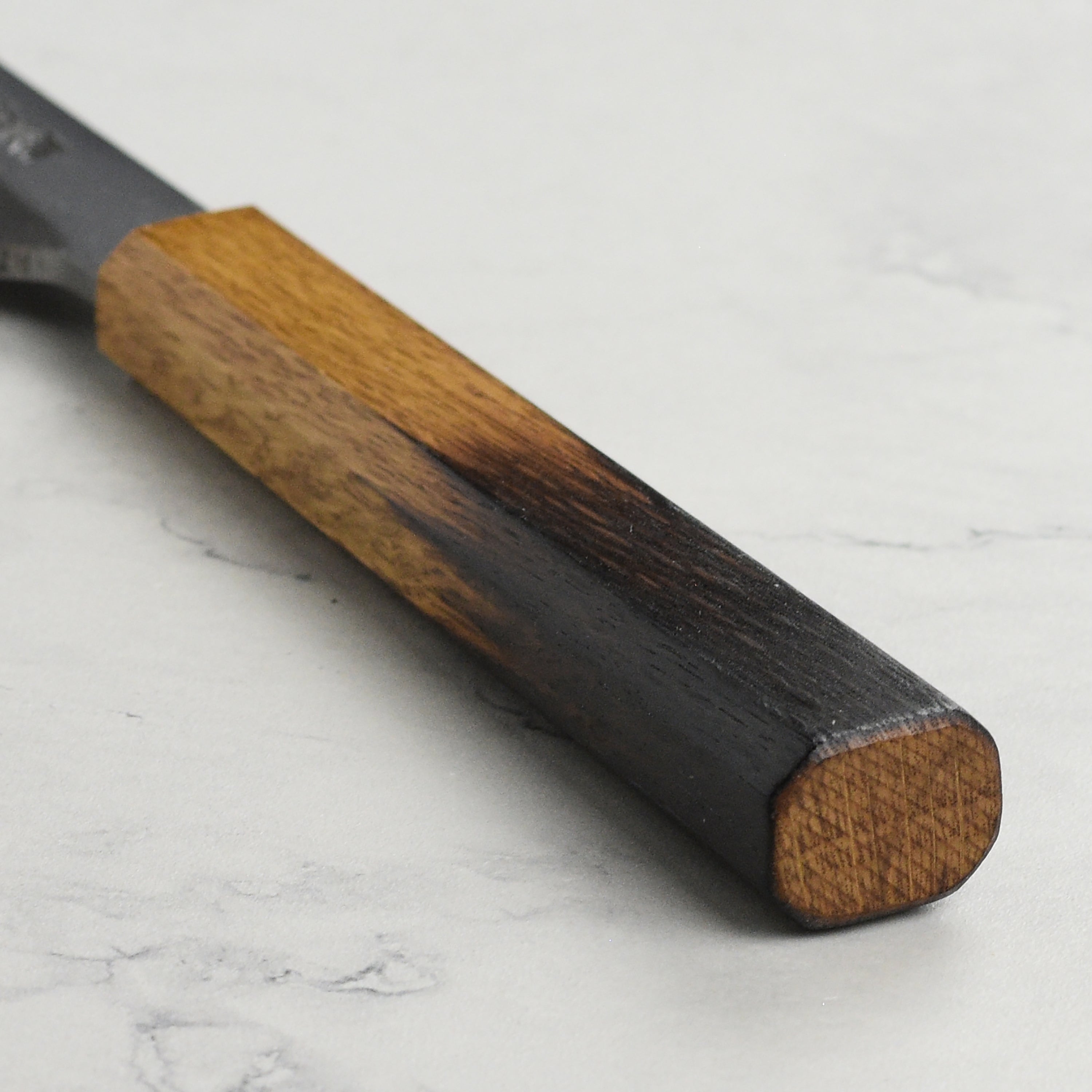 Close-up of the Takayuki sashimi knife highlighting the Aogami steel craftsmanship and single bevel edge.