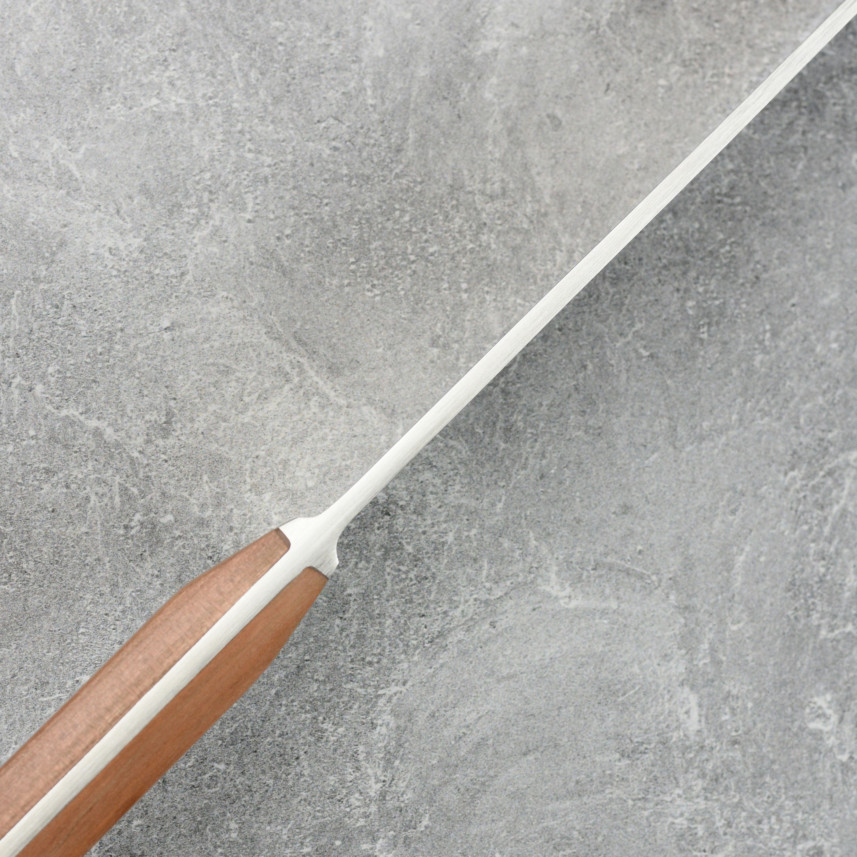 Chef slicing vegetables with the Karl Gude 10.25-inch chefs knife in a professional kitchen