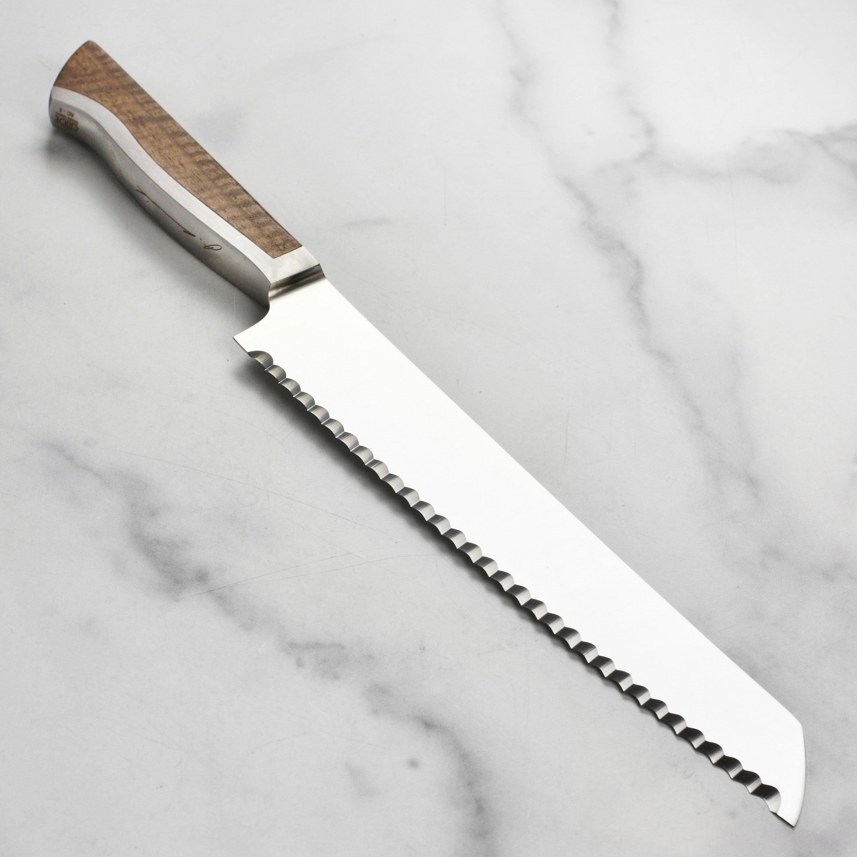 Close-up of high carbon steel bread knife showing blade sharpness