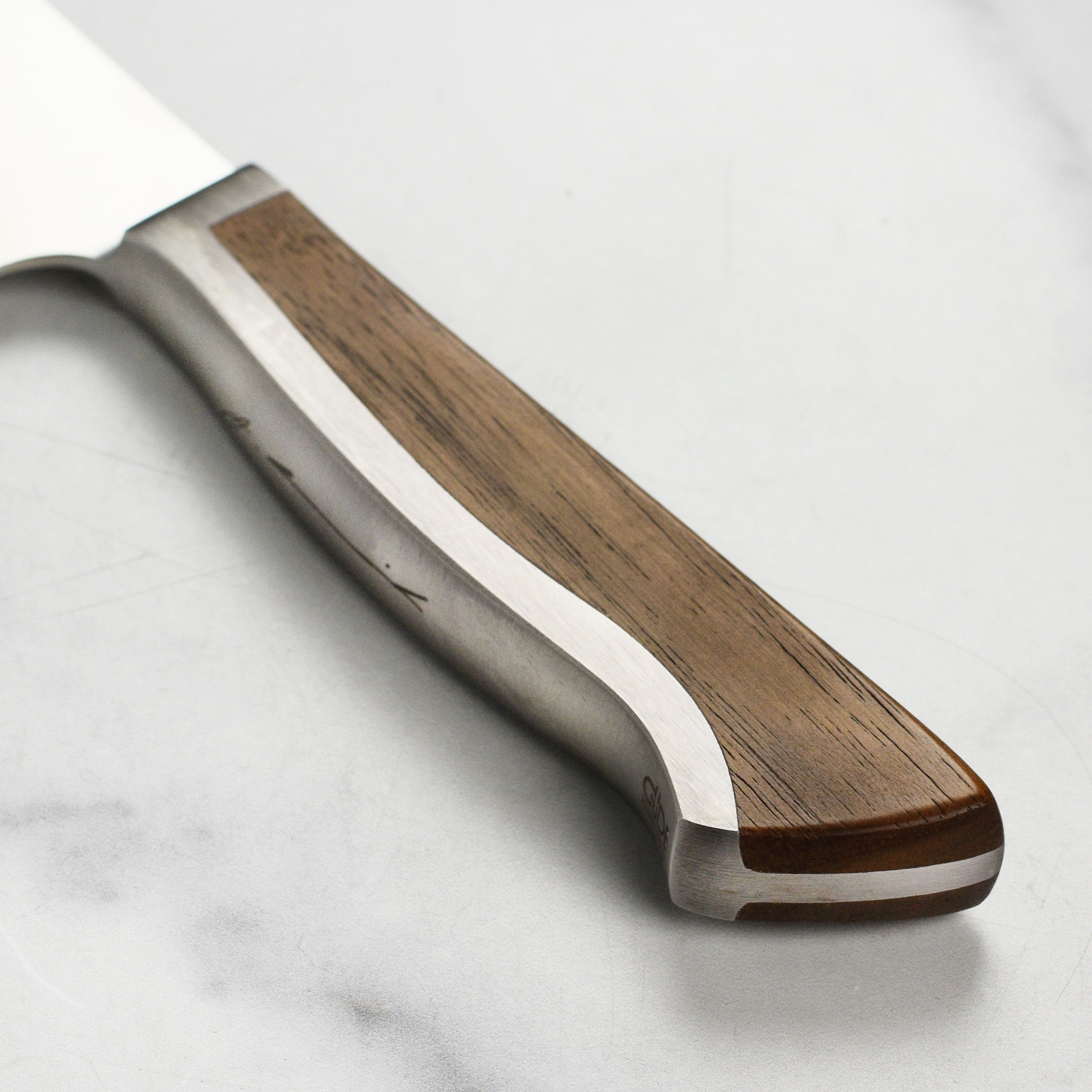 Close-up of high carbon steel bread knife showing blade sharpness