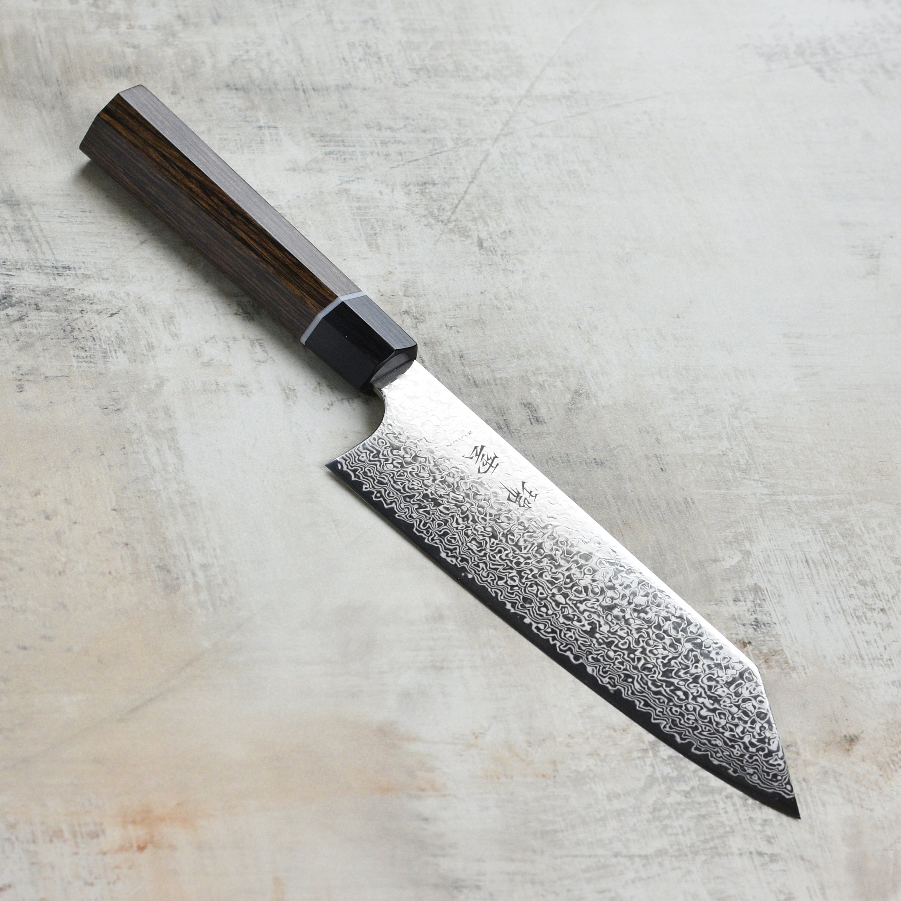 Close-up of the Seki Kanetsugu Zuiun SG2 7-Inch Bunka Knife highlighting its precision edge.