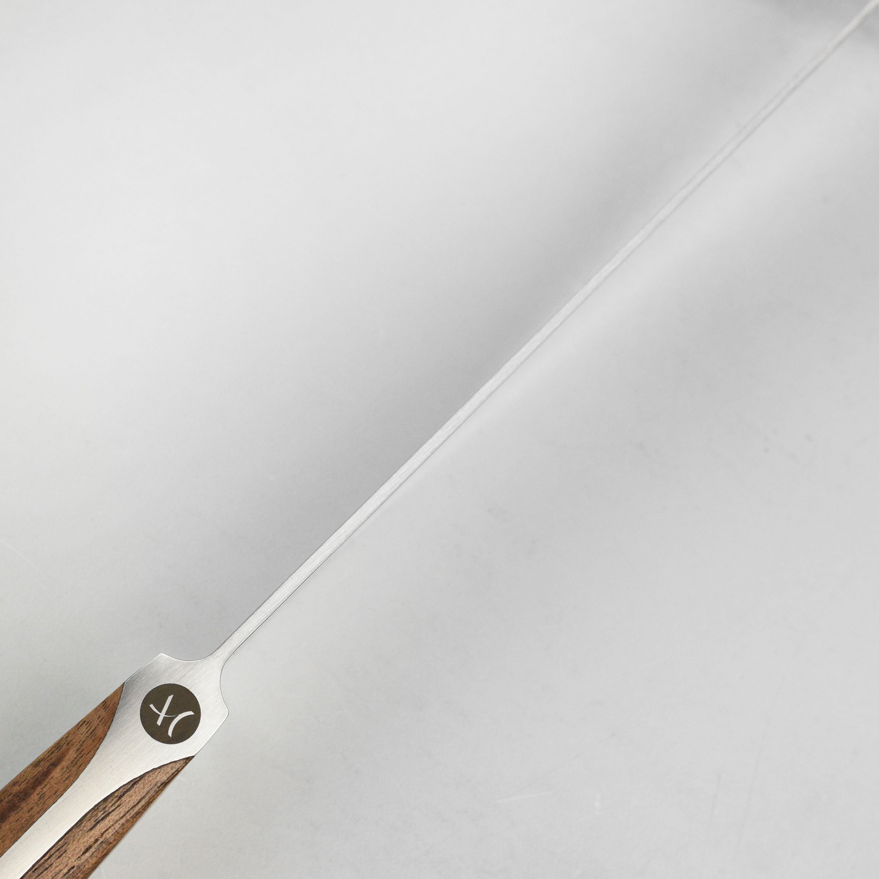 Gude Caminada knife demonstrating precision cuts on a roast.