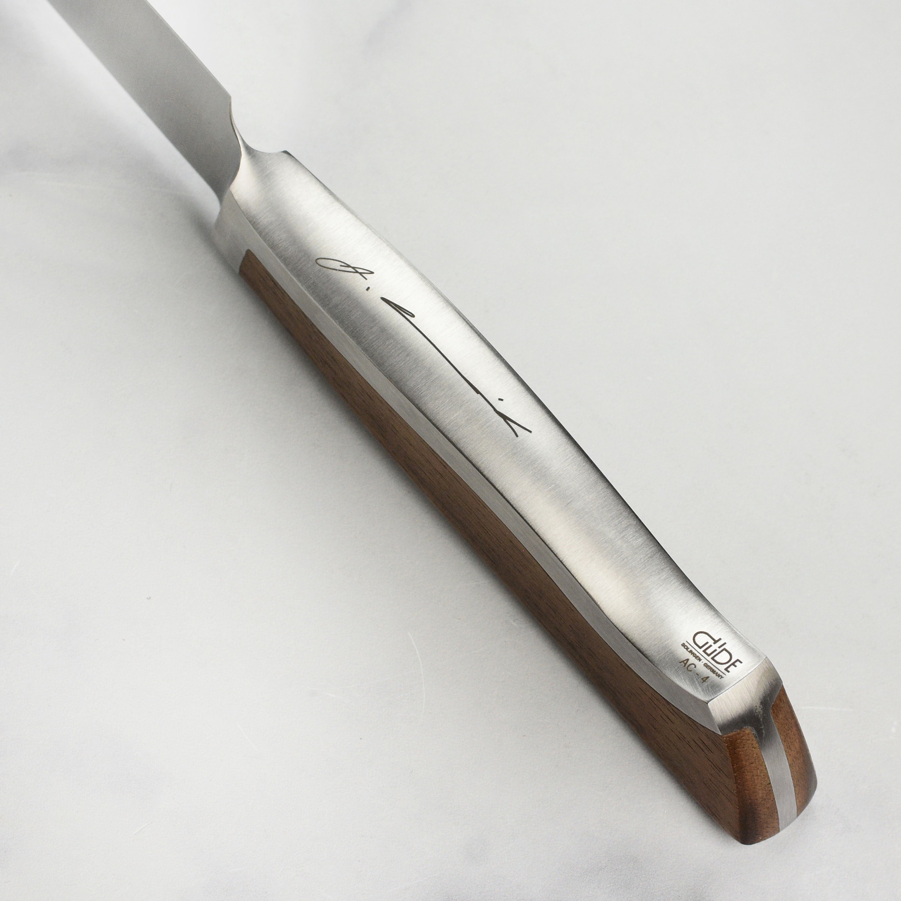 Gude Caminada slicing knife with walnut handle in a kitchen setting.