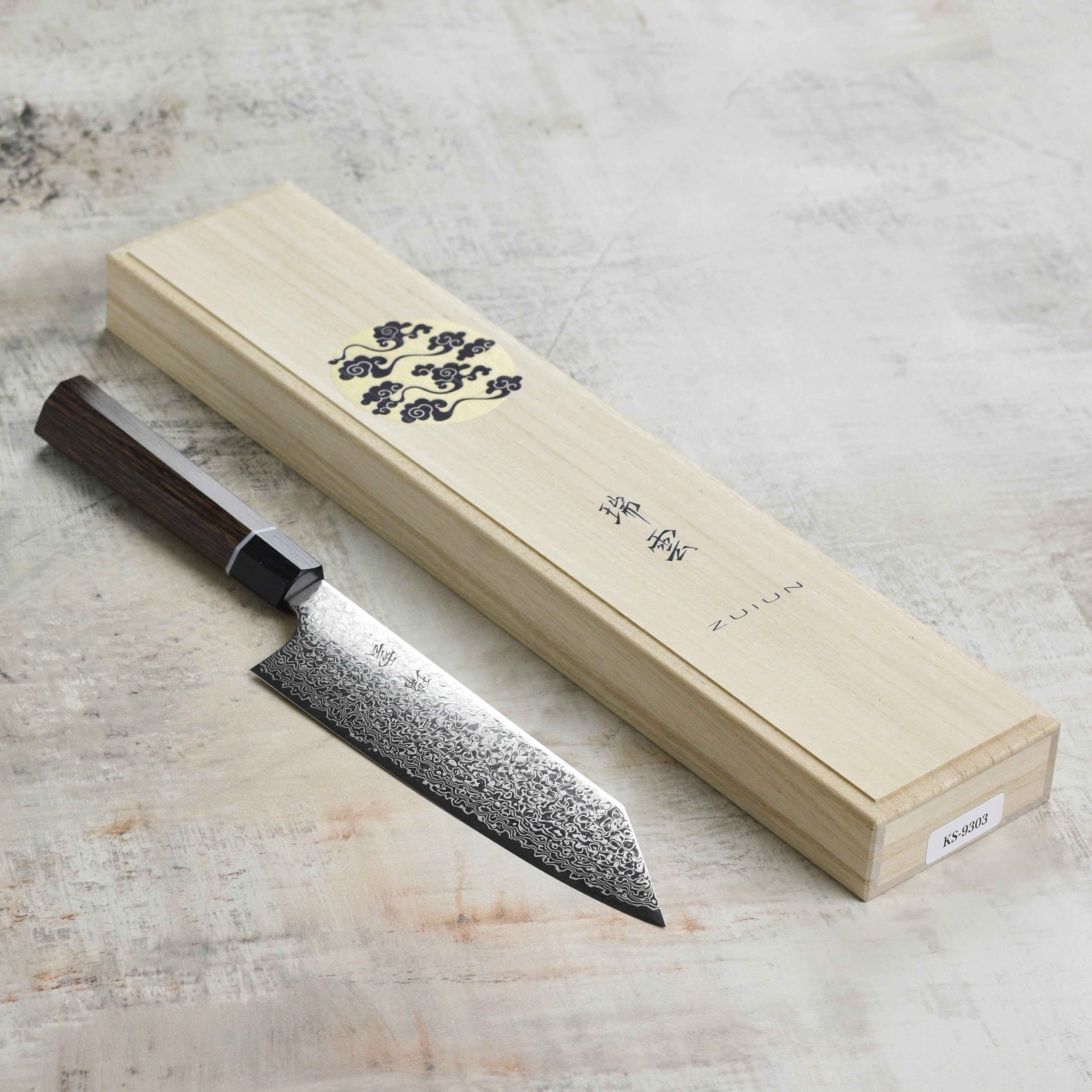 Stylish presentation of the Seki Kanetsugu Zuiun SG2 7-Inch Bunka Knife against a dark background.