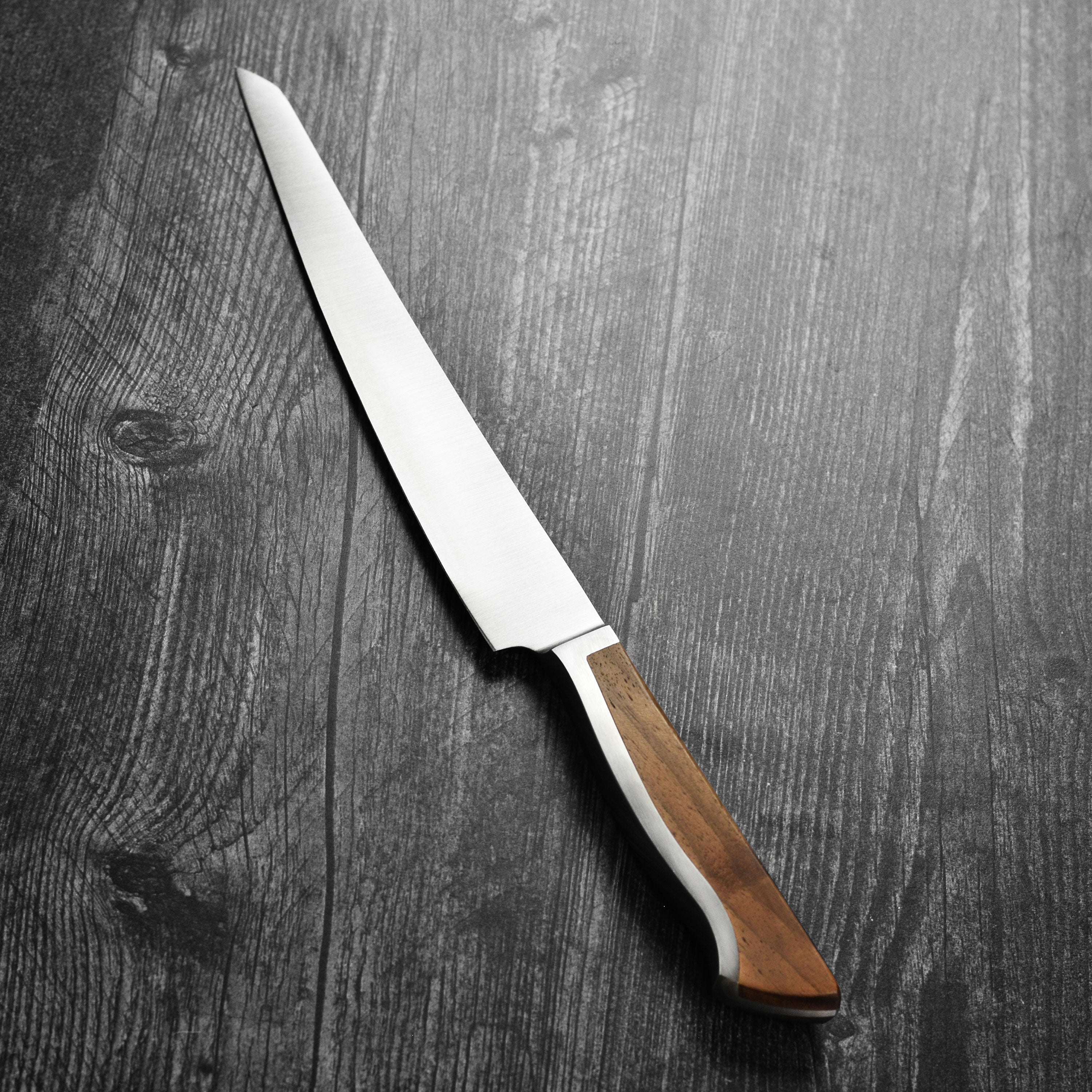 Gude Caminada knife demonstrating precision cuts on a roast.