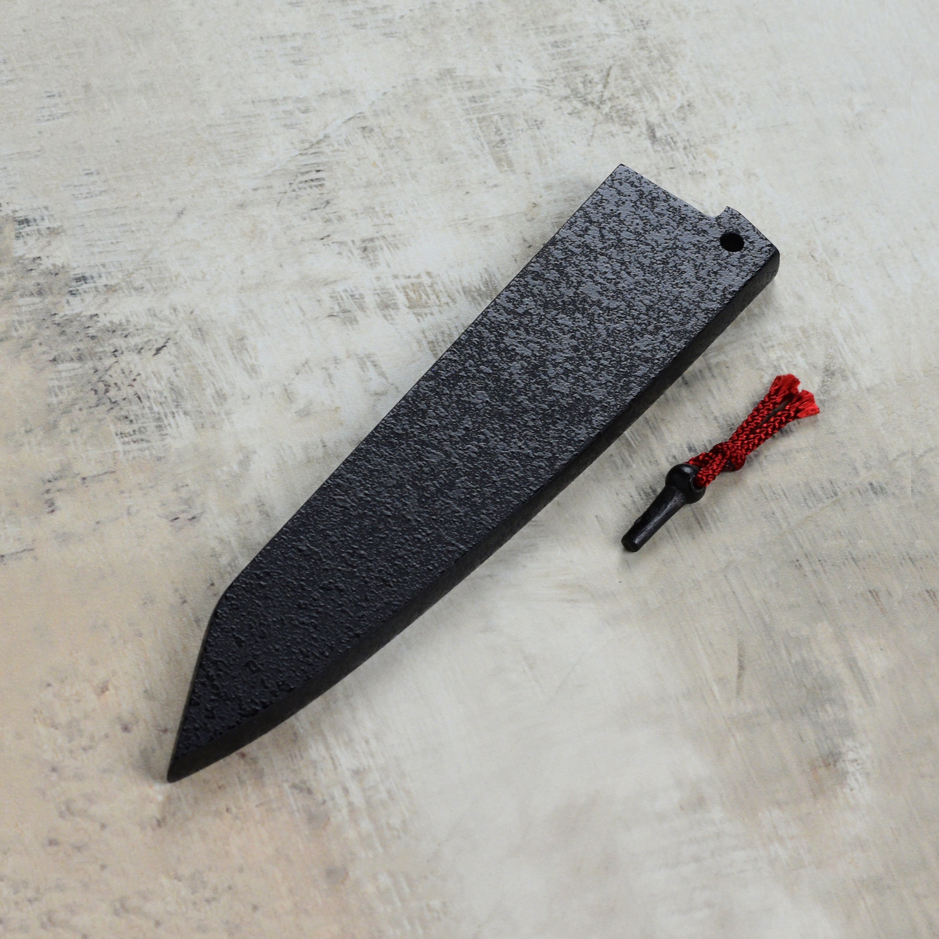 Display of the Zuiun 5.9" petty knife saya in a kitchen setting, demonstrating its elegant design and functionality.