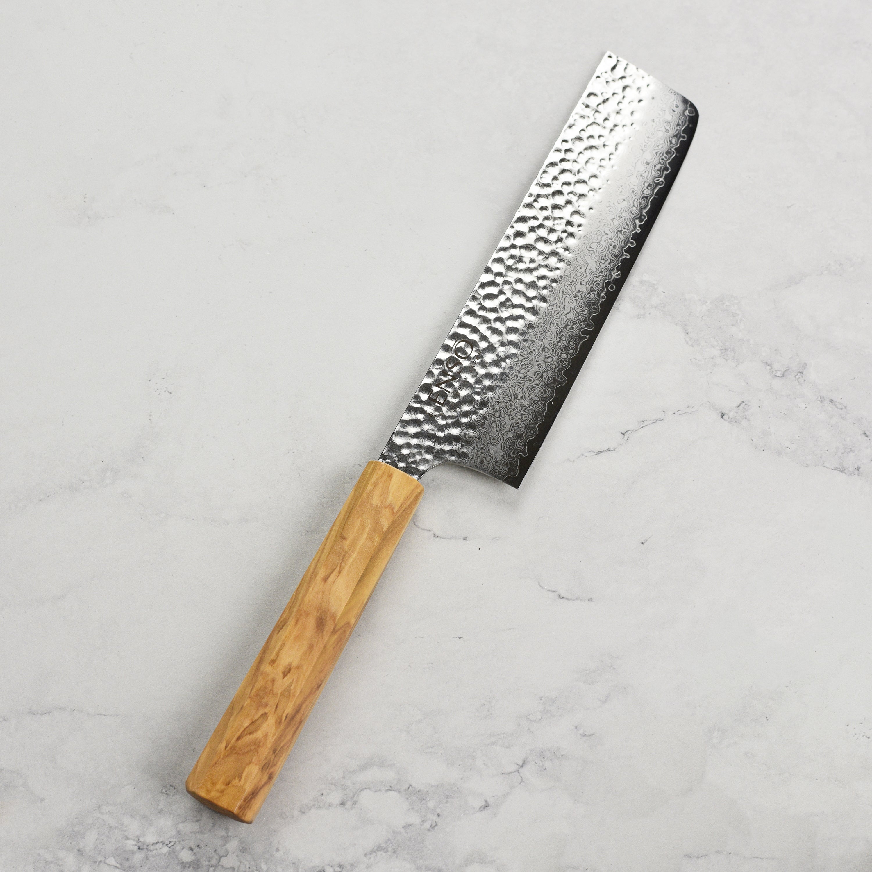 Elegant display of the Premium Olivewood Nakiri Knife alongside fresh herbs and ingredients.