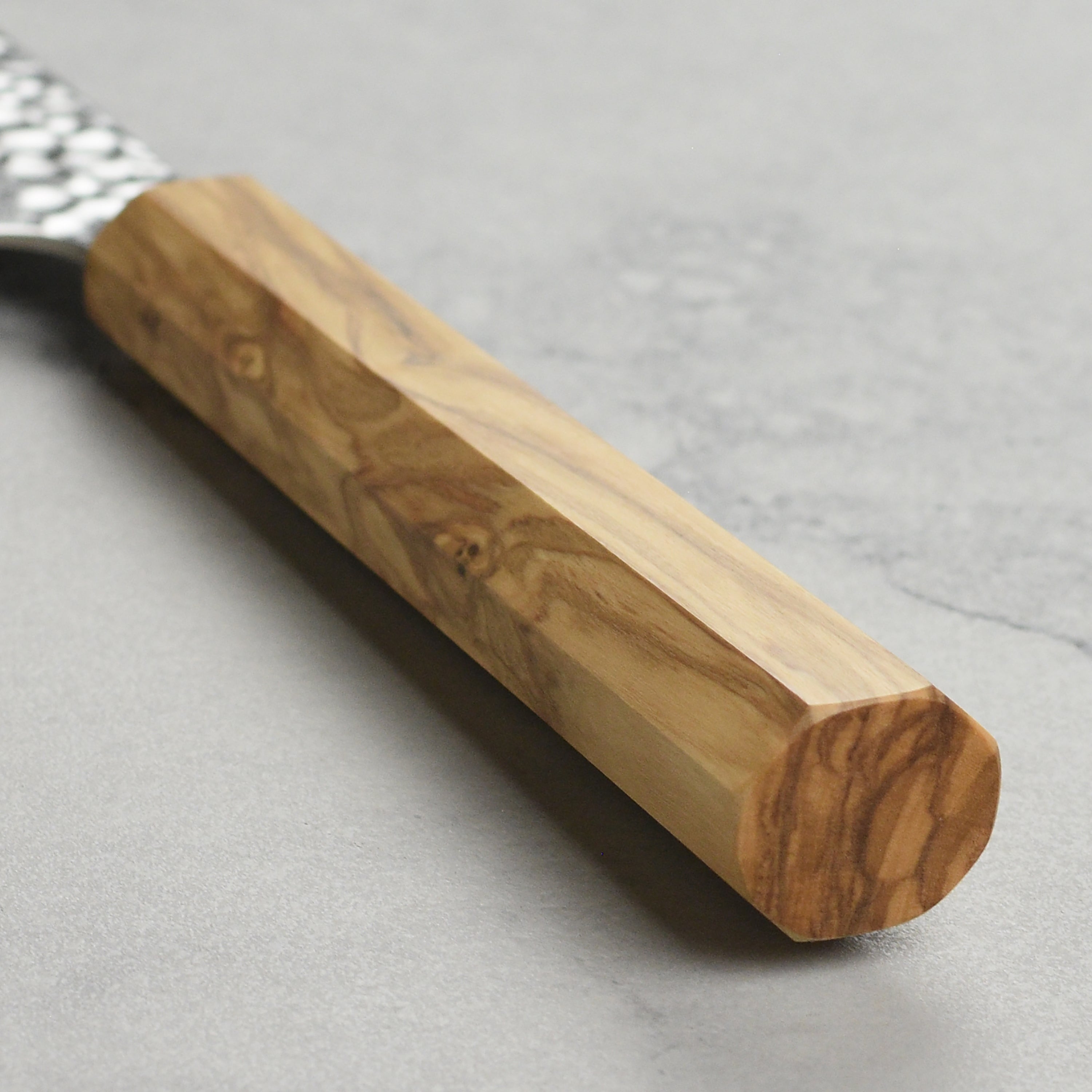 Close-up of the olivewood handle of the Enso petty knife, emphasizing grip and comfort.