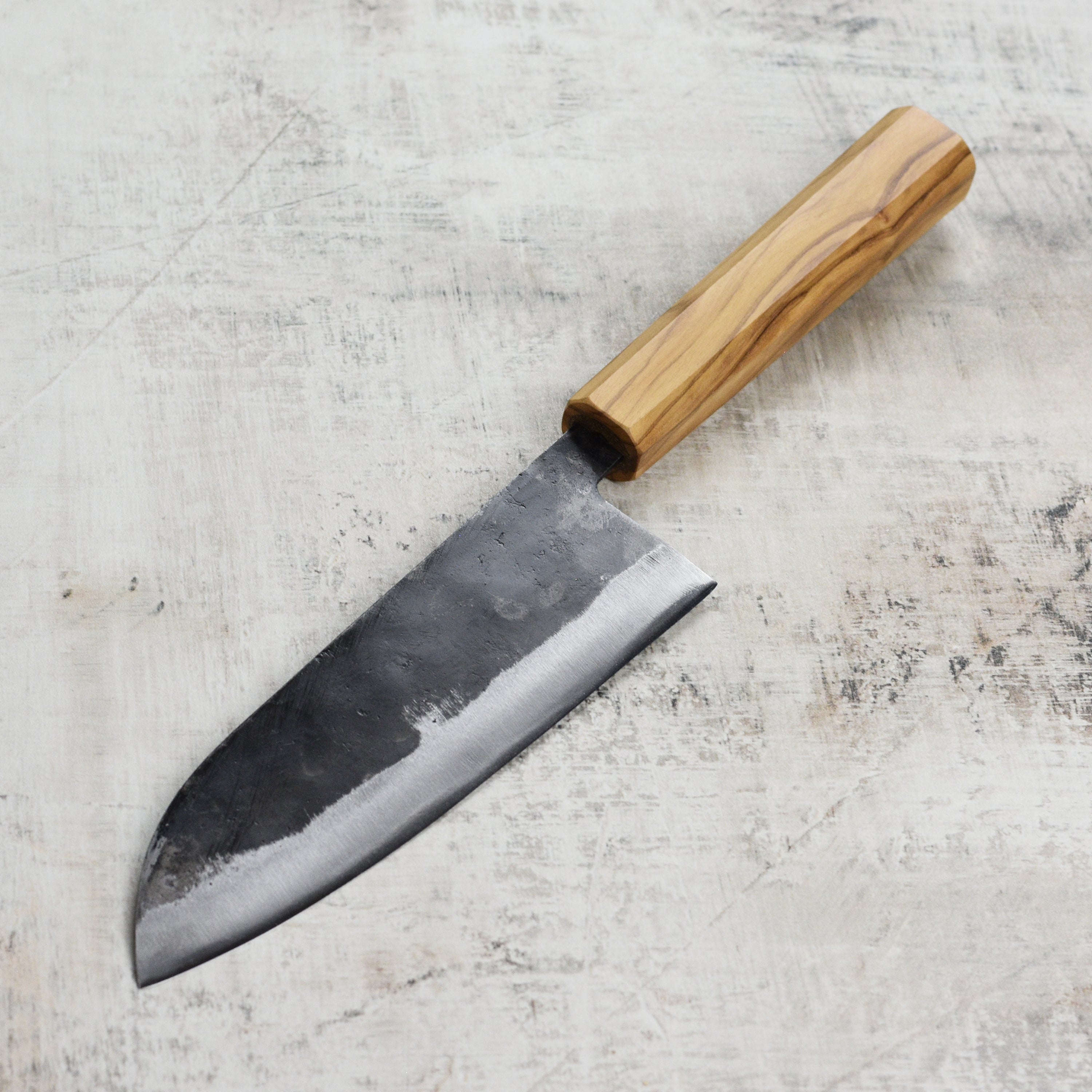 Chef slicing vegetables with the Japanese knives set in a modern kitchen