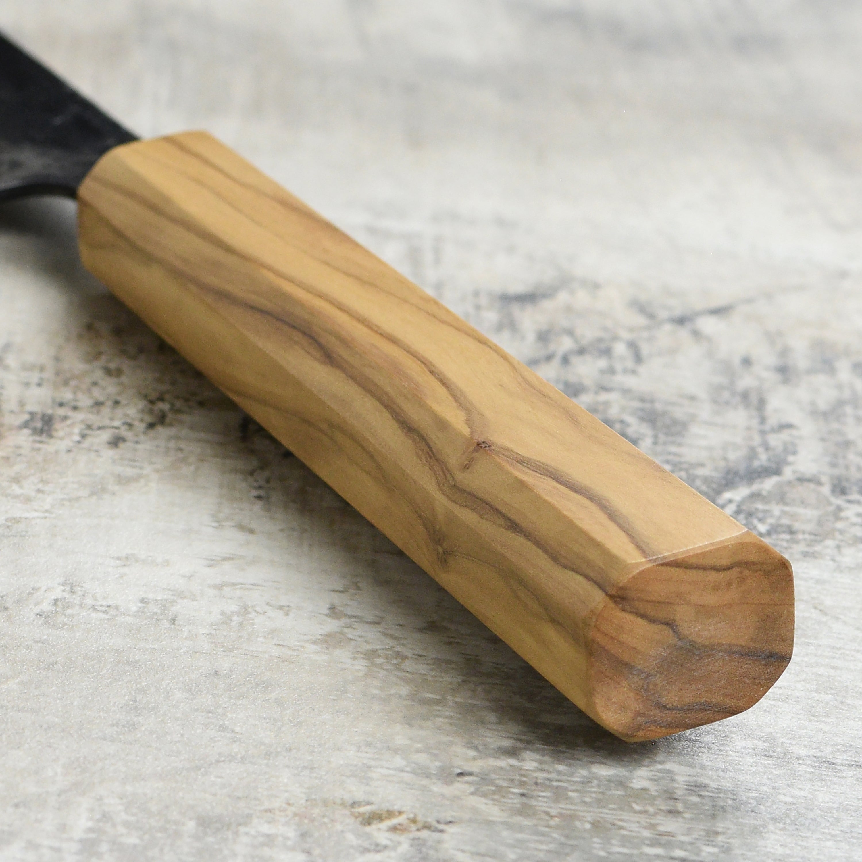 Close-up of Kurouchi finish and sharp edge on the 6.5-inch Santoku knife