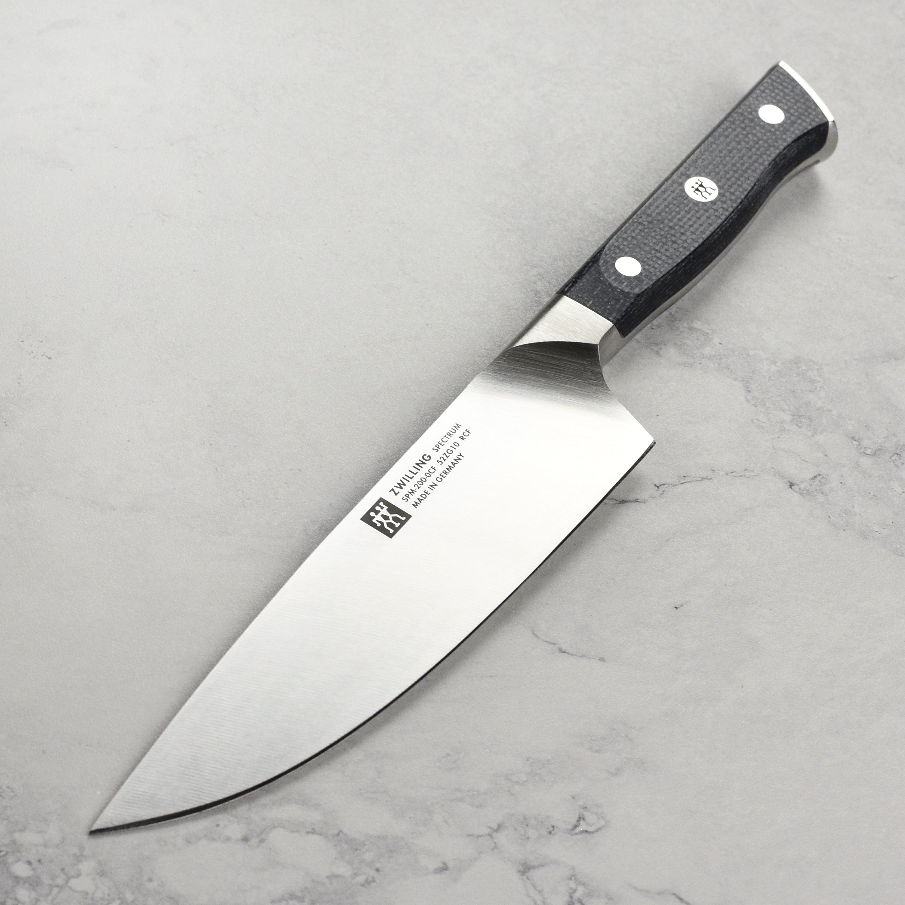 The Zwilling Spectrum 8-inch chef's knife with sharp blade and ergonomic handle for precision cuts