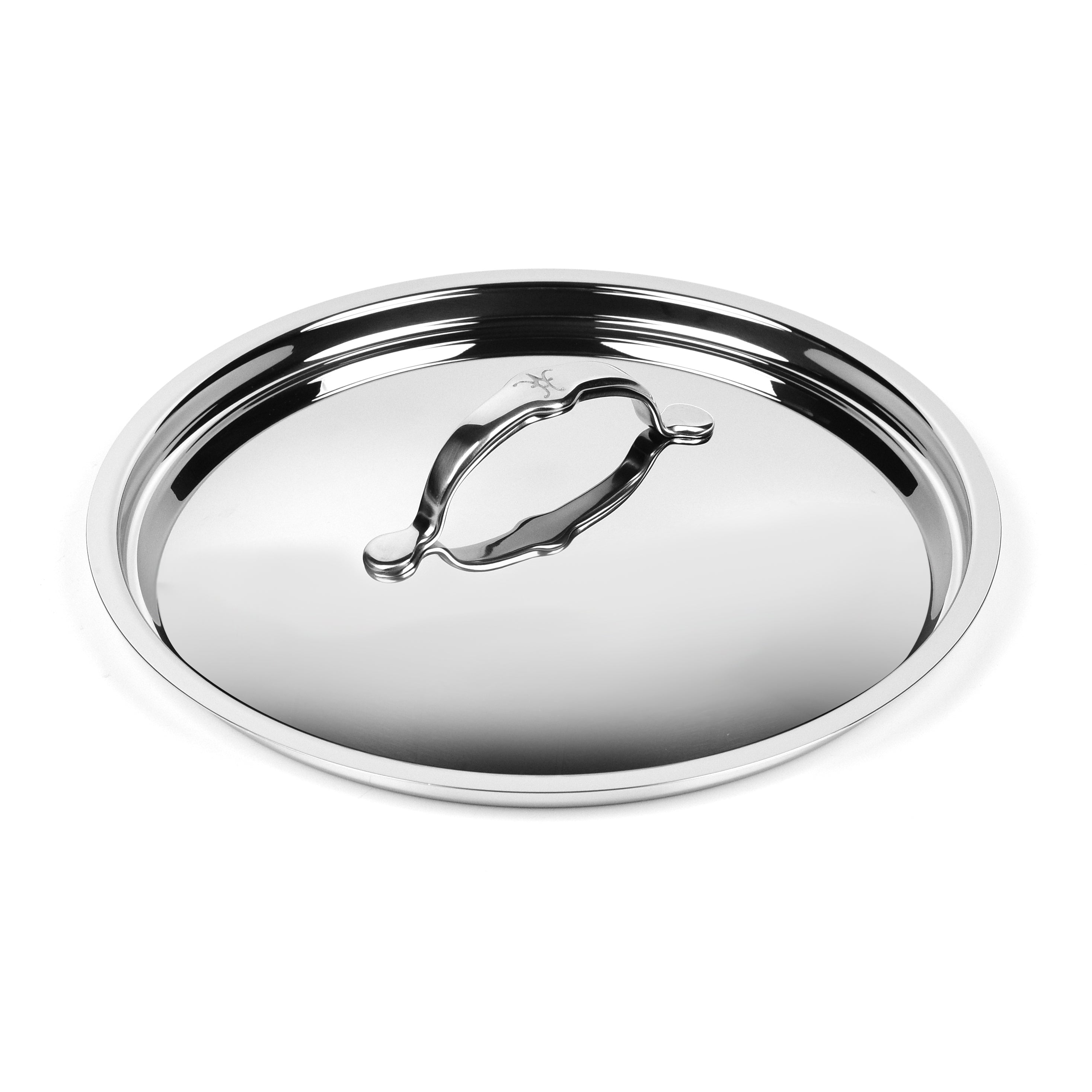 Close-up of stainless steel skillet lid resting on a skillet