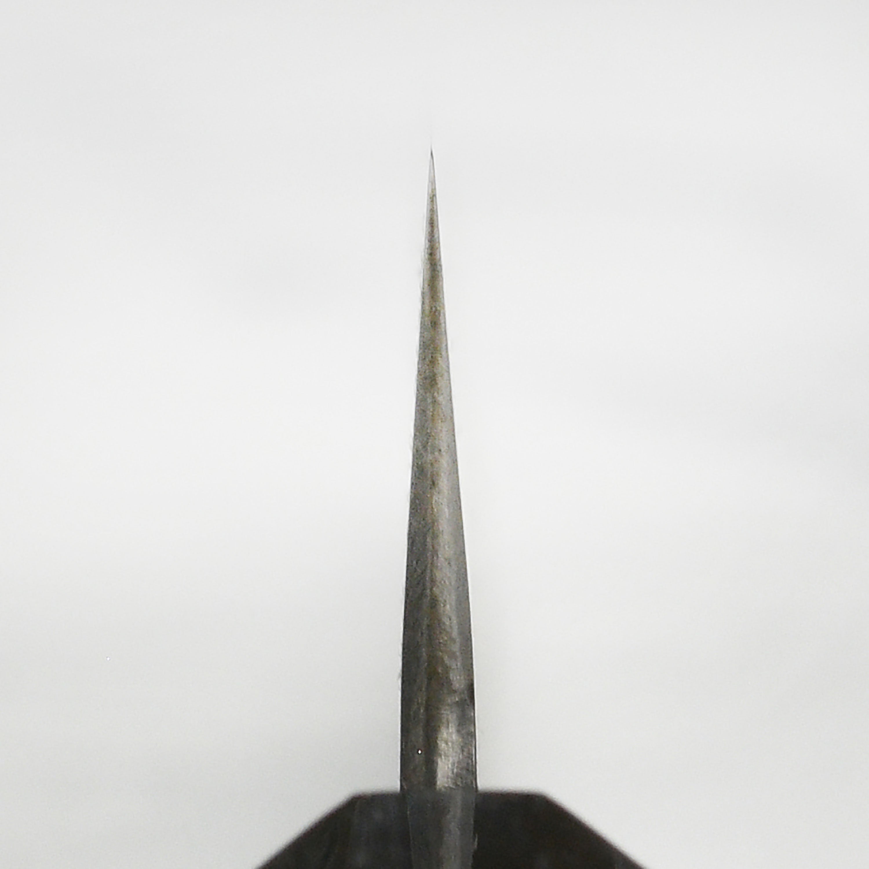 Close-up of the Hinoura 9.4" Sujihiki Knife demonstrating its precision cutting capabilities.