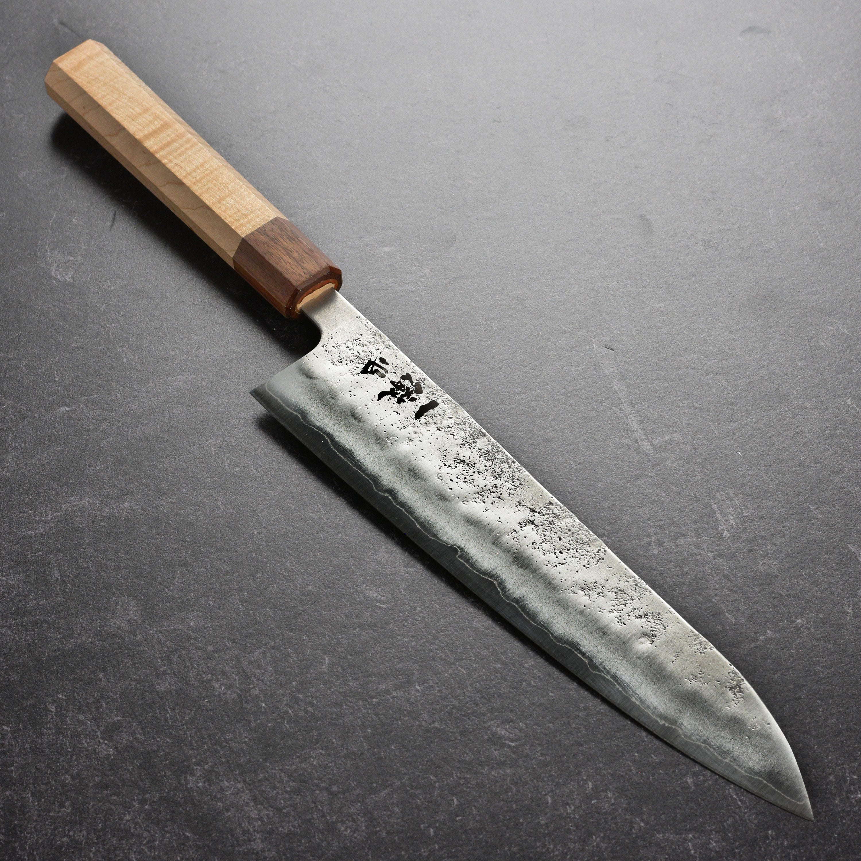 Ittetsu Ginsan Nashiji Gyuto knife angled view highlighting the blade's sharpness.