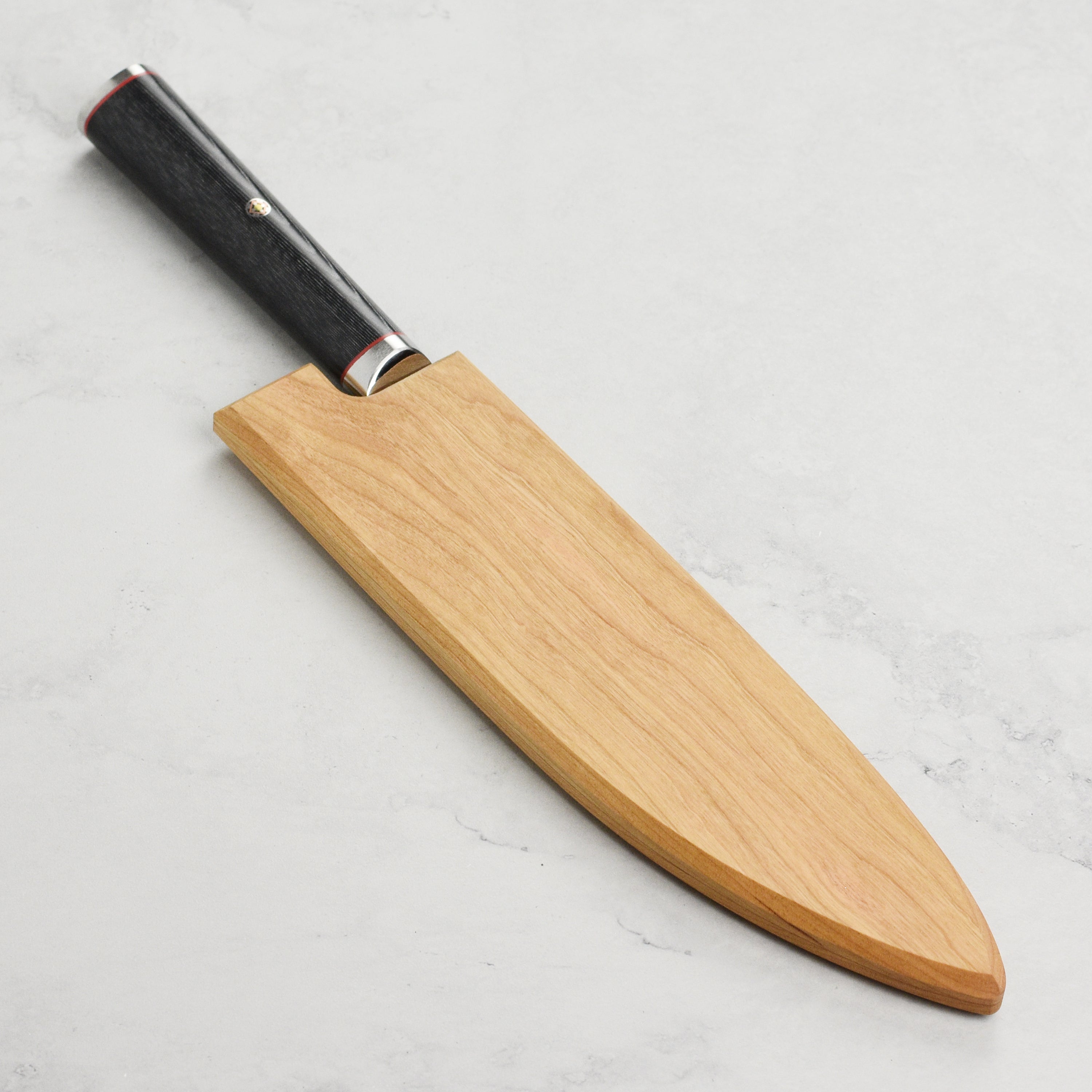 Handcrafted cherry wood saya securely holding an 8-inch knife, highlighting its elegant design and functionality.