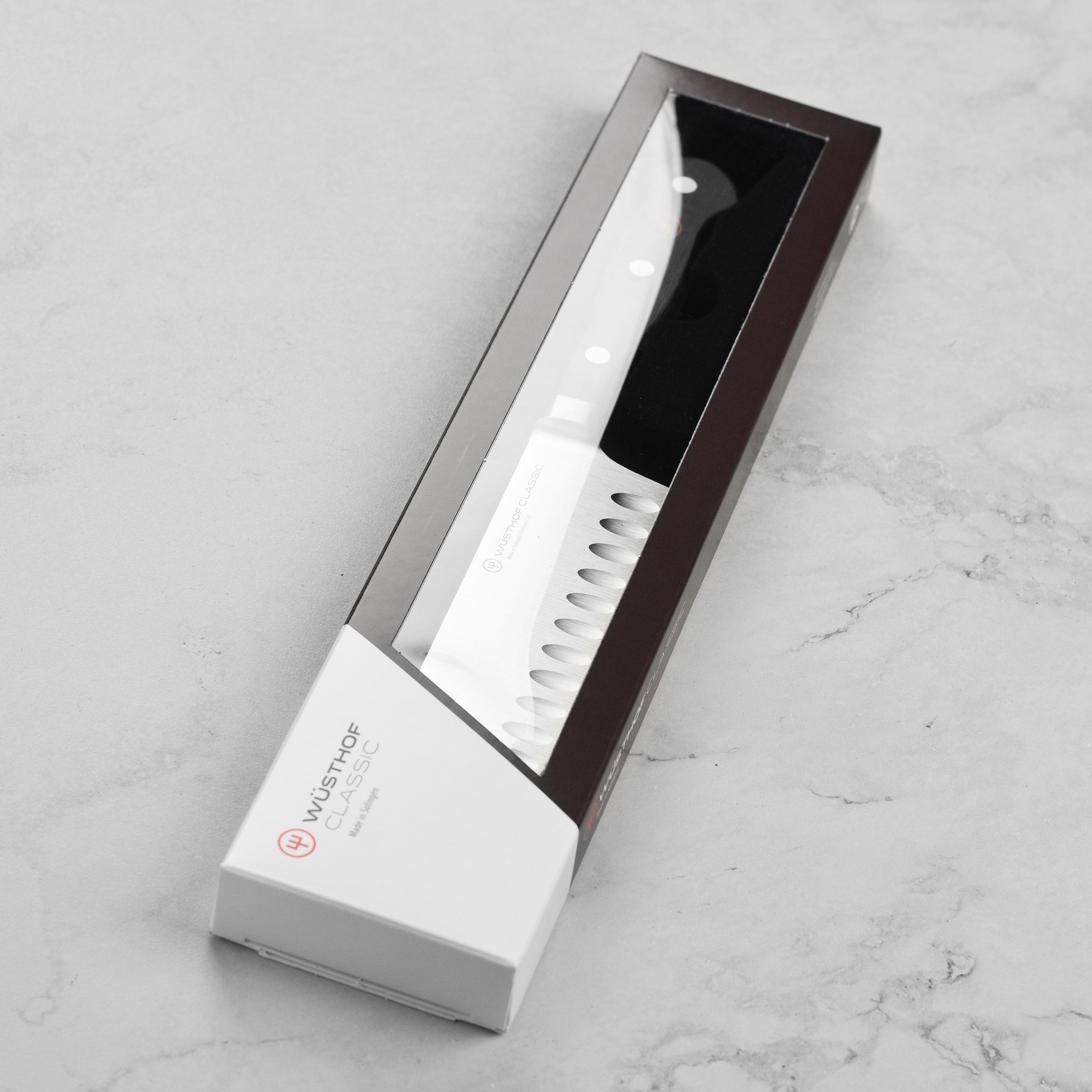 Side view of the Wusthof Classic knife handle highlighting its triple rivets and ergonomic shape