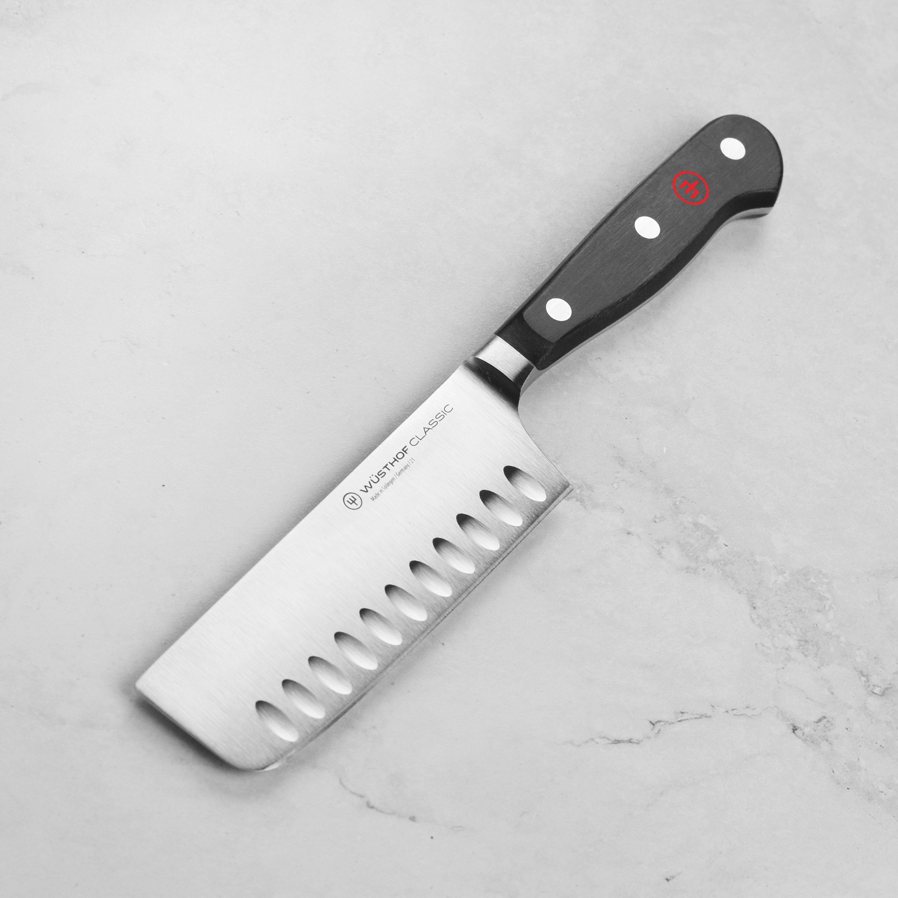 Angled view of the Wusthof Nakiri knife showing its hollow edge for reduced drag