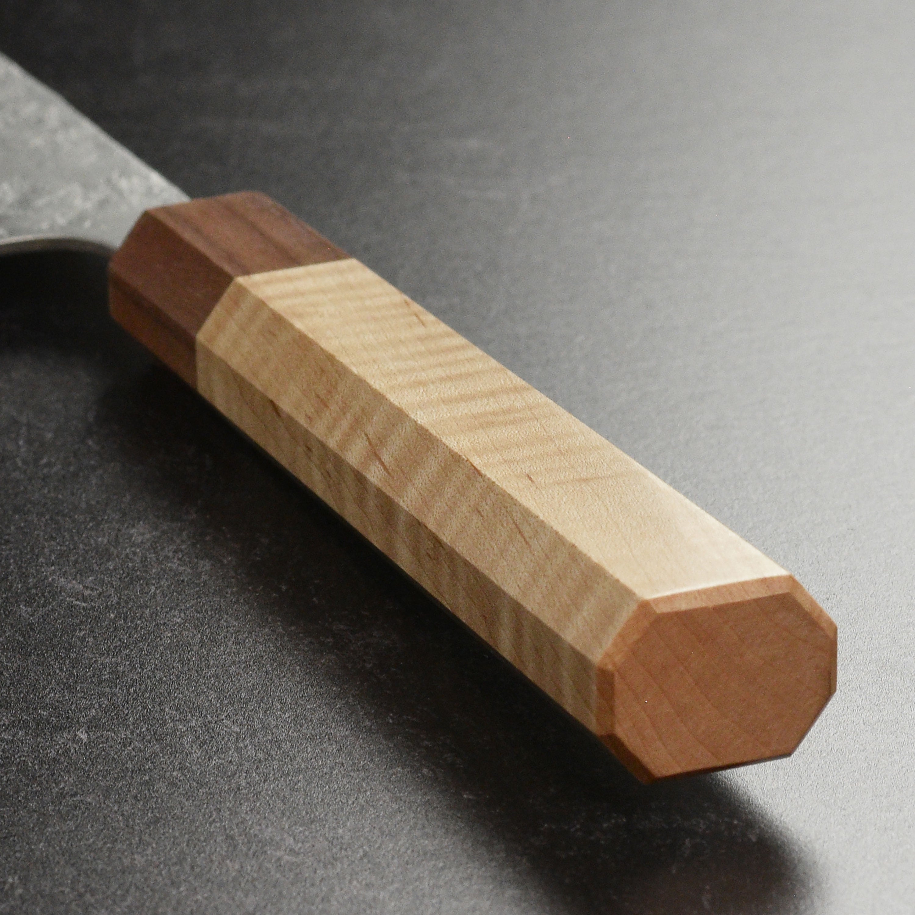 Close-up of the ergonomic handle of the Ittetsu Ginsan Nashiji Gyuto knife.