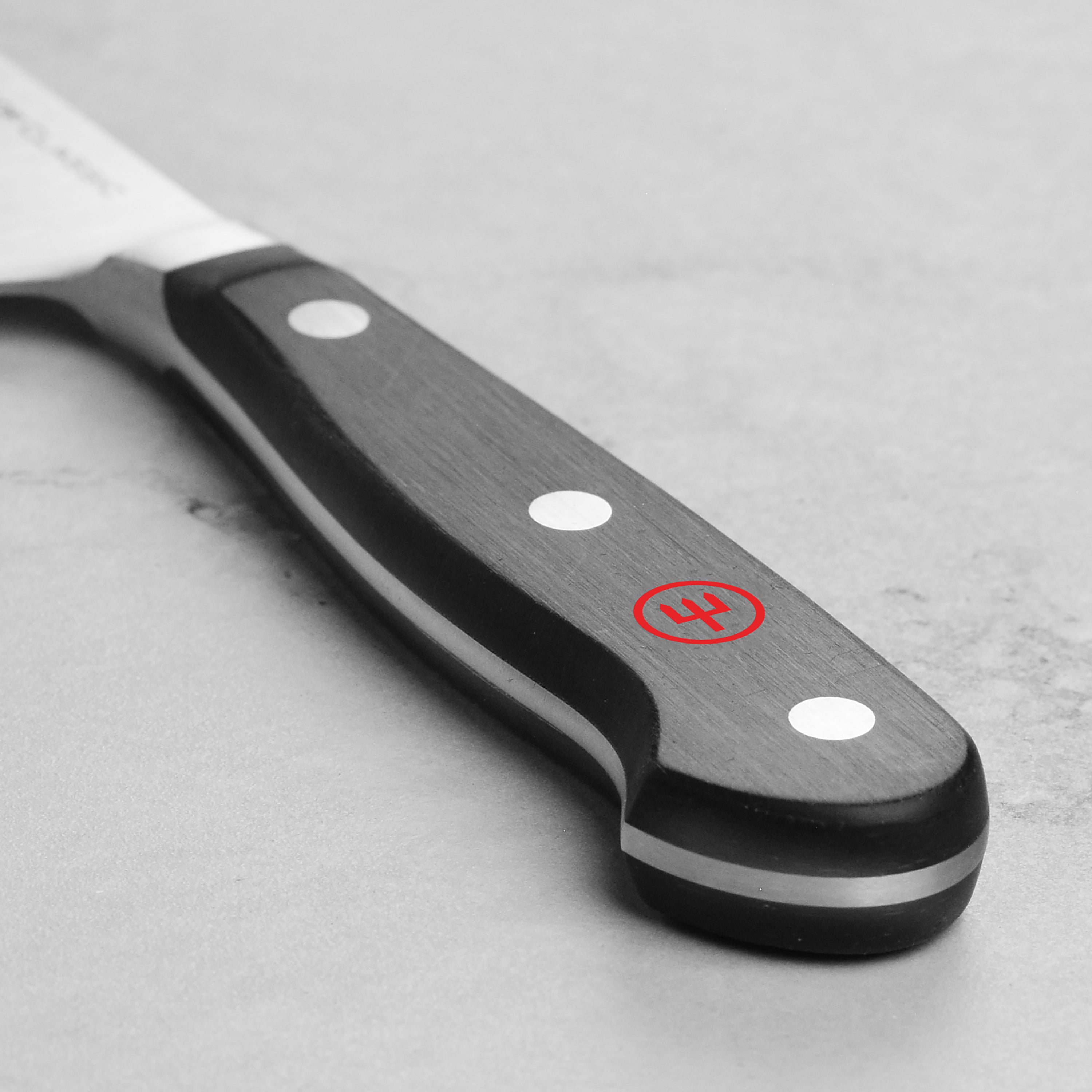 Close-up of the knife cutting assorted vegetables — showcasing precision and clean slices