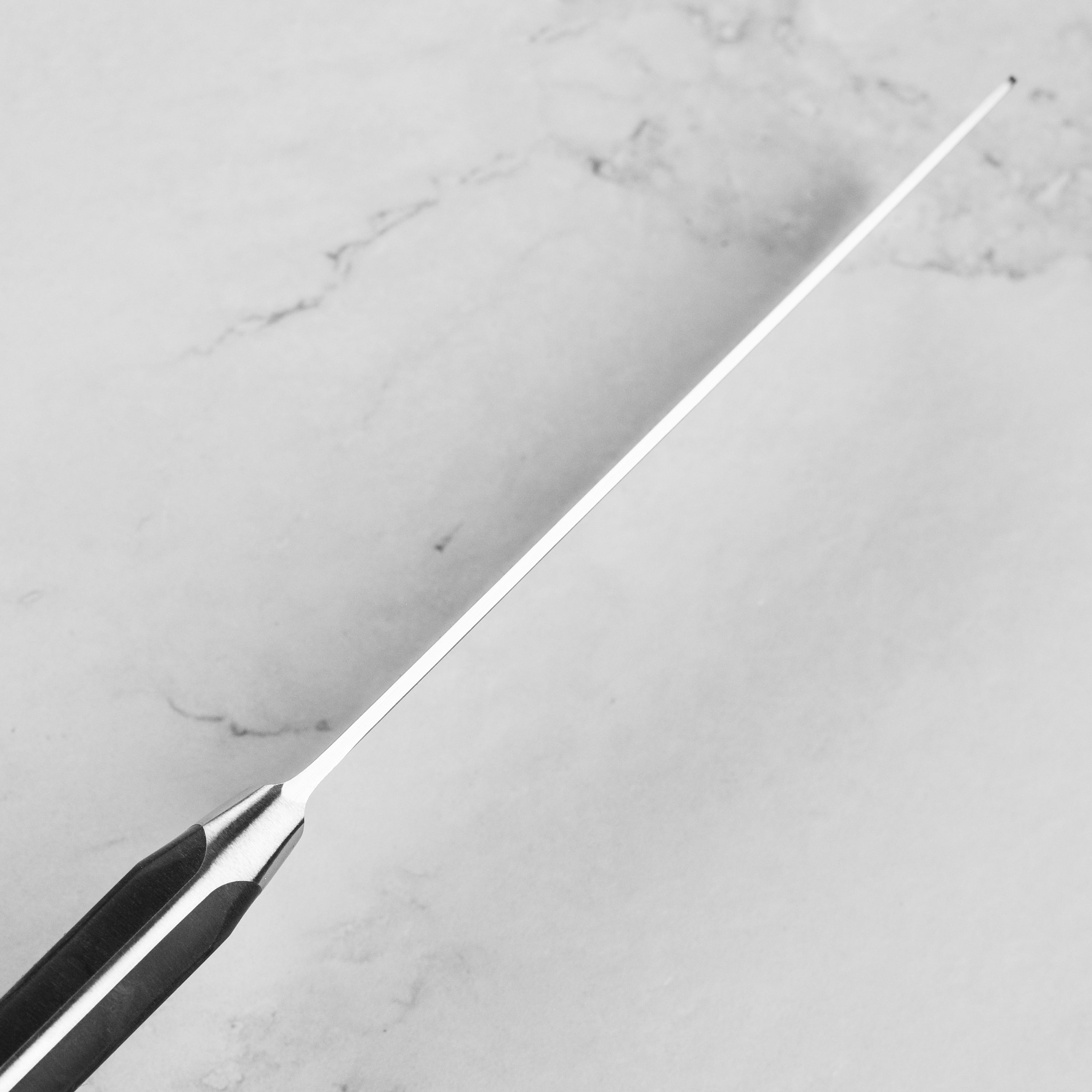 Side view of the Wusthof Classic knife handle highlighting its triple rivets and ergonomic shape