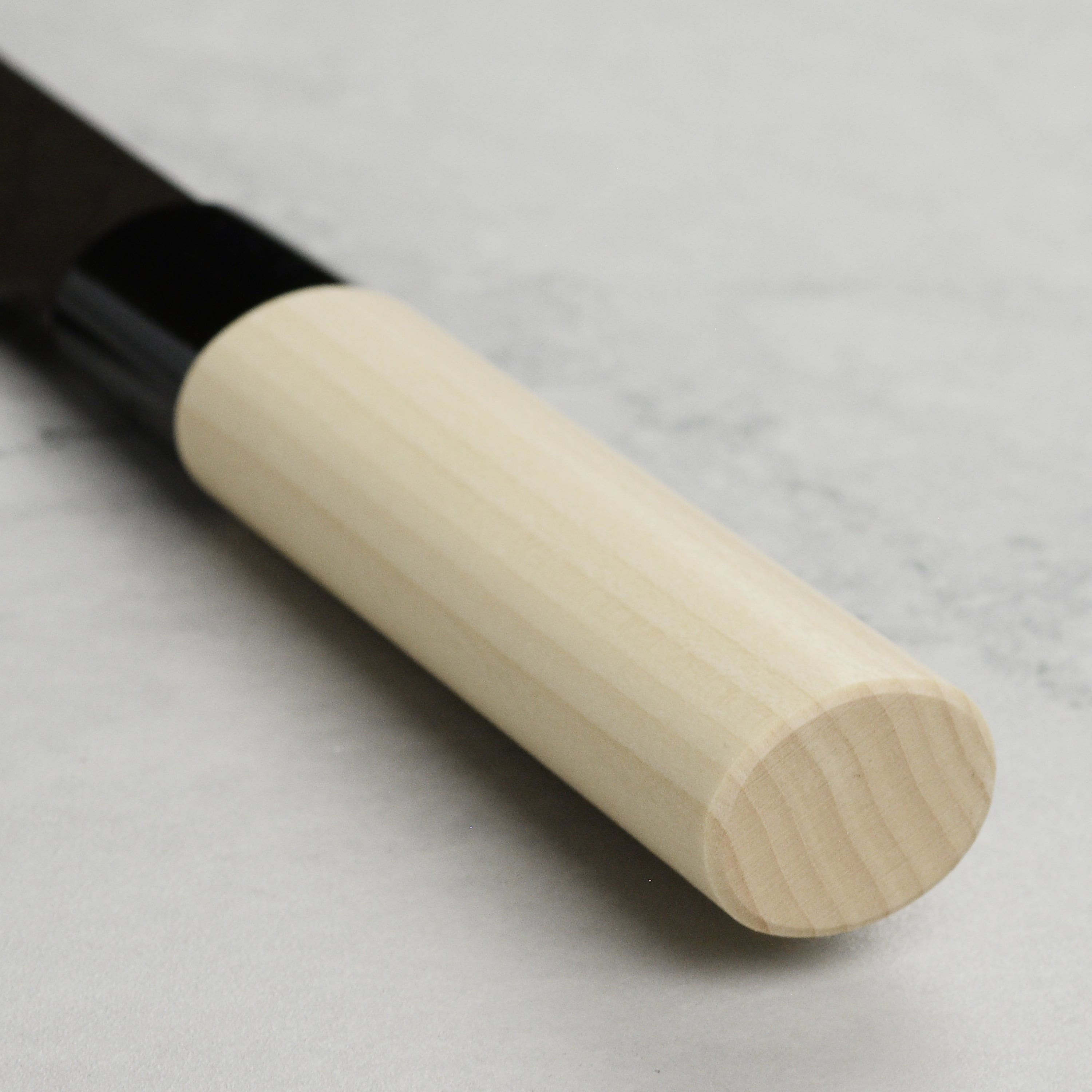 Close-up view of the blade of the Tojiro Gyuto knife, emphasizing the hammered texture and fine craftsmanship.