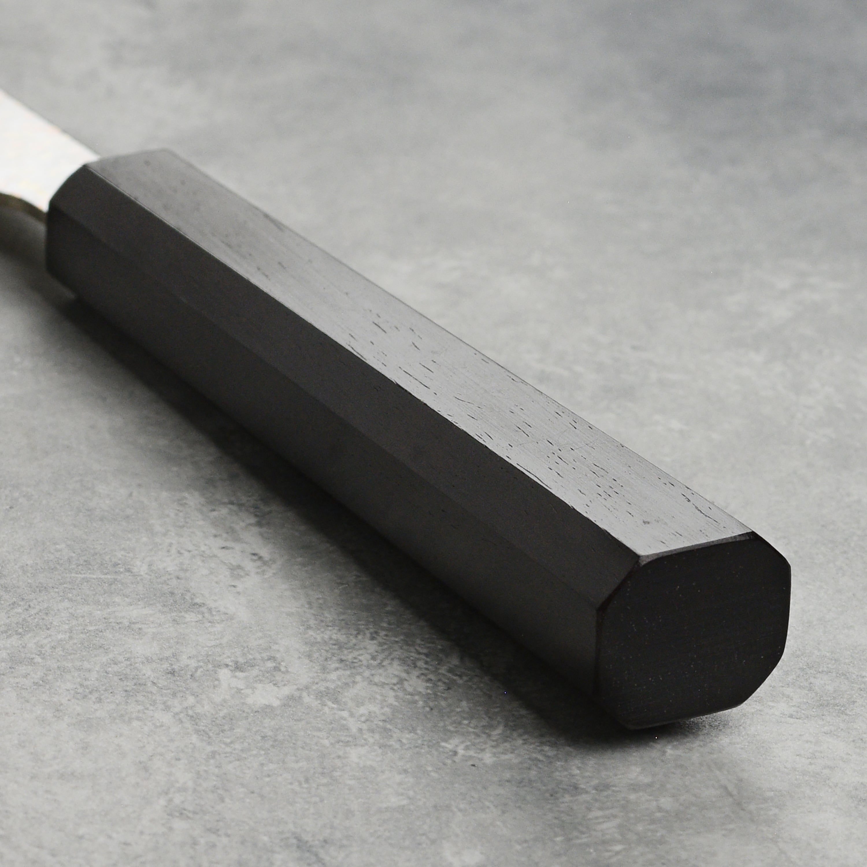 Handmade rainbow Damascus chef knife with ebony handle for precise slicing
