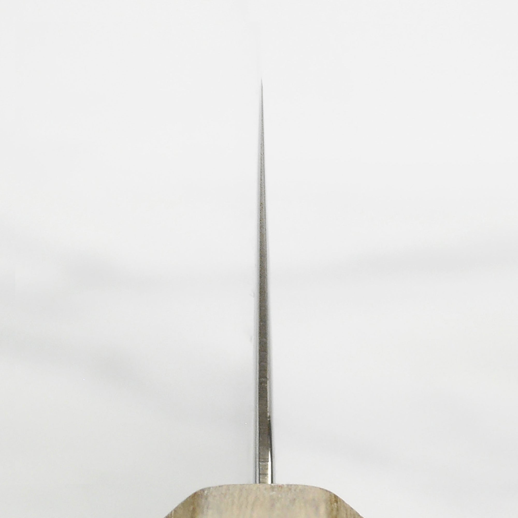 Ittetsu AUS10 Spiral Damascus Santoku Knife on a wooden cutting board, showcasing its sharp blade and ergonomic handle.