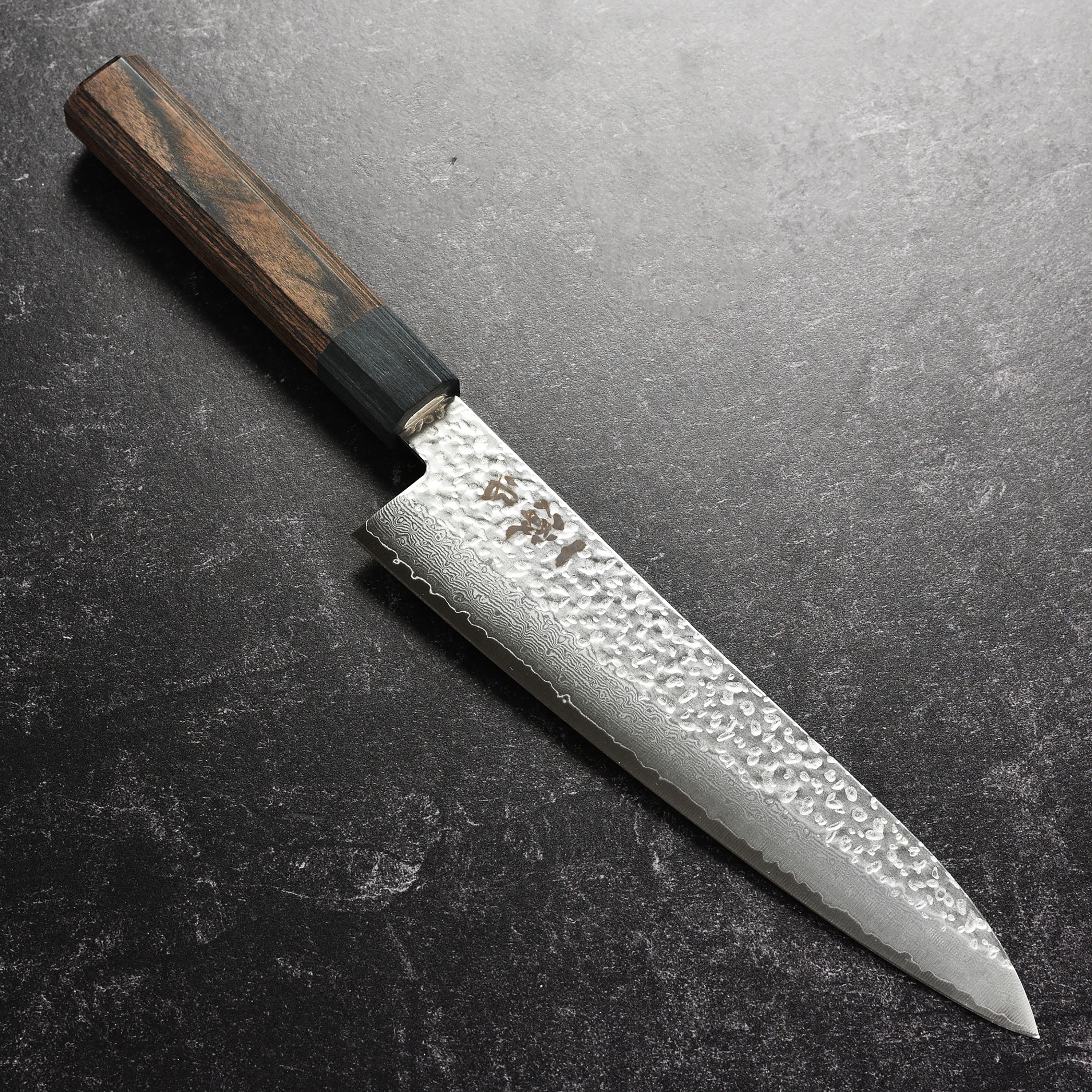 Close-up of the Ittetsu VG10 Damascus Gyuto blade showing hammered finish and VG10 steel core