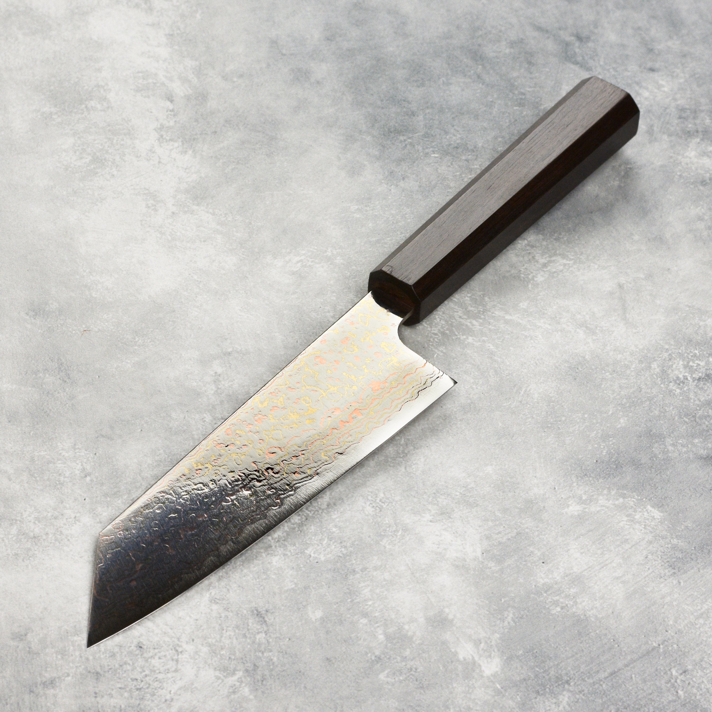 Saji Rainbow Damascus Bunka Knife displayed in its wooden gift box, reflecting craftsmanship and luxury.