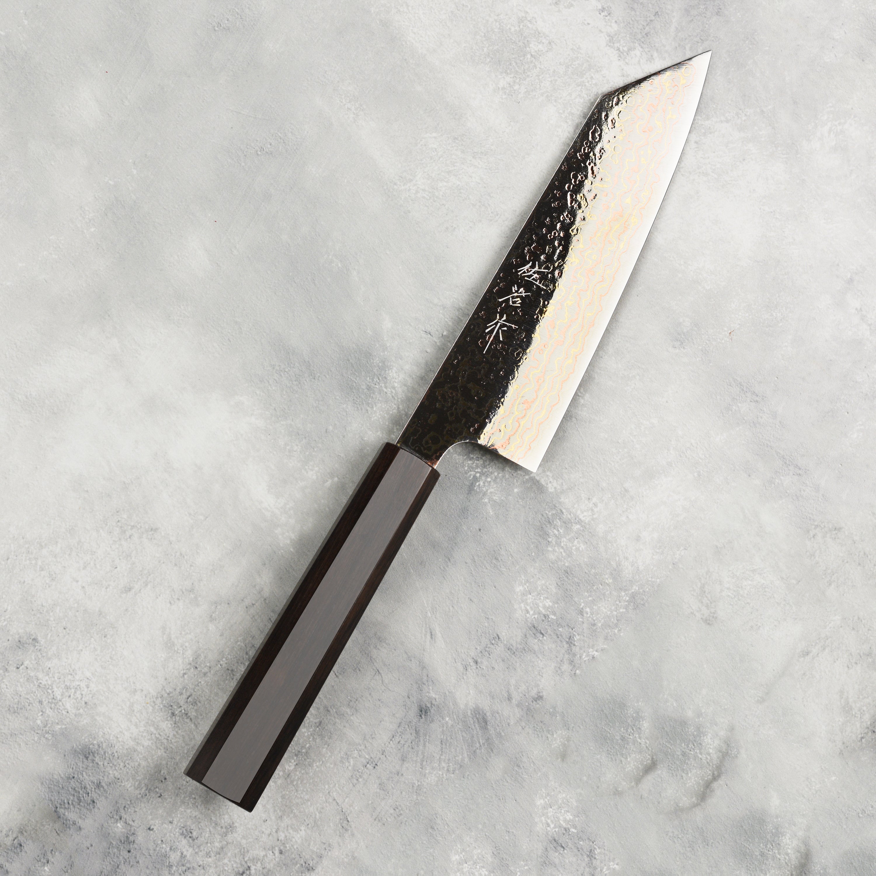 Saji Rainbow Damascus Bunka Knife displayed in its wooden gift box, reflecting craftsmanship and luxury.
