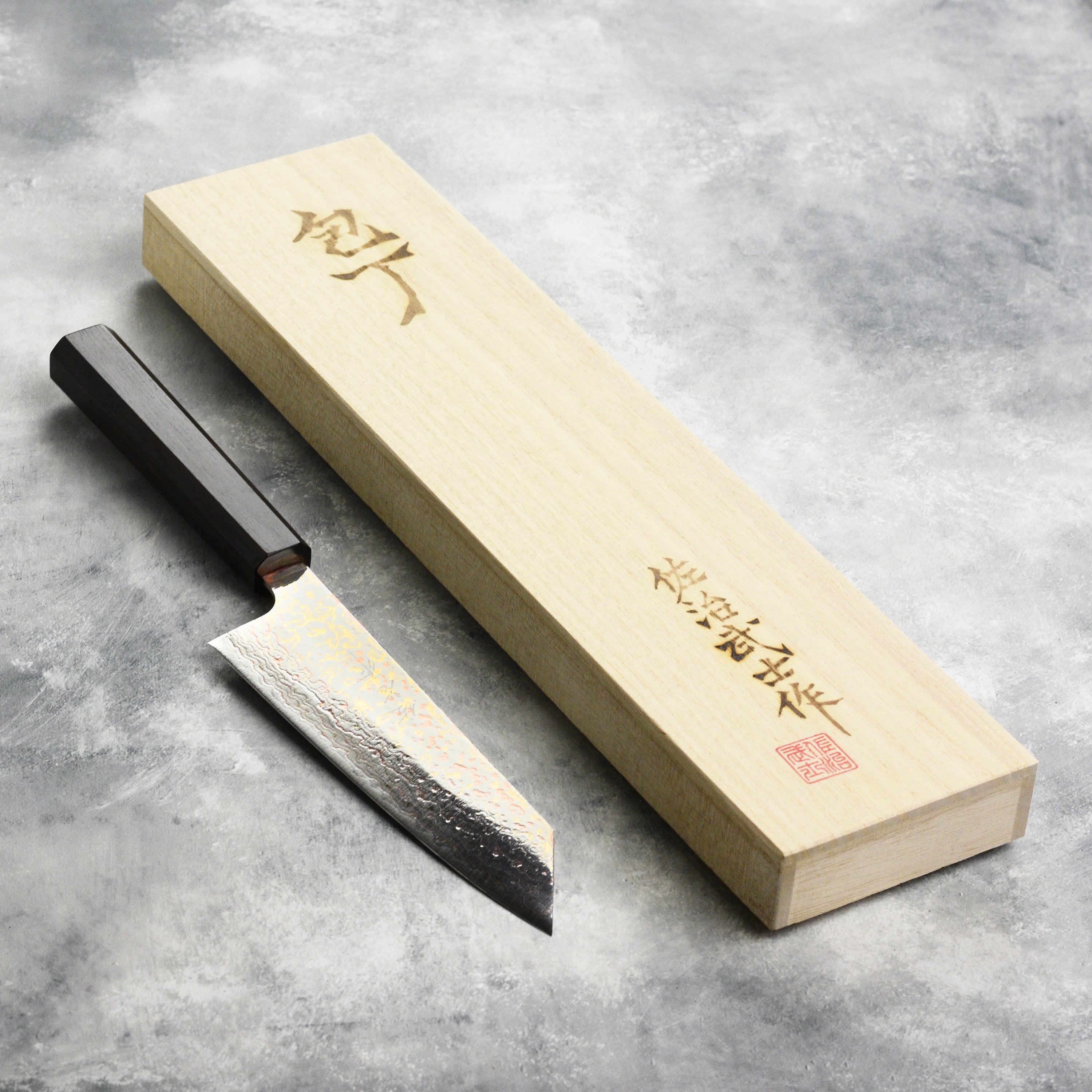 Saji Premium Rainbow Damascus Bunka Chef Knife angled view showcasing the mirror finish and Damascus pattern.