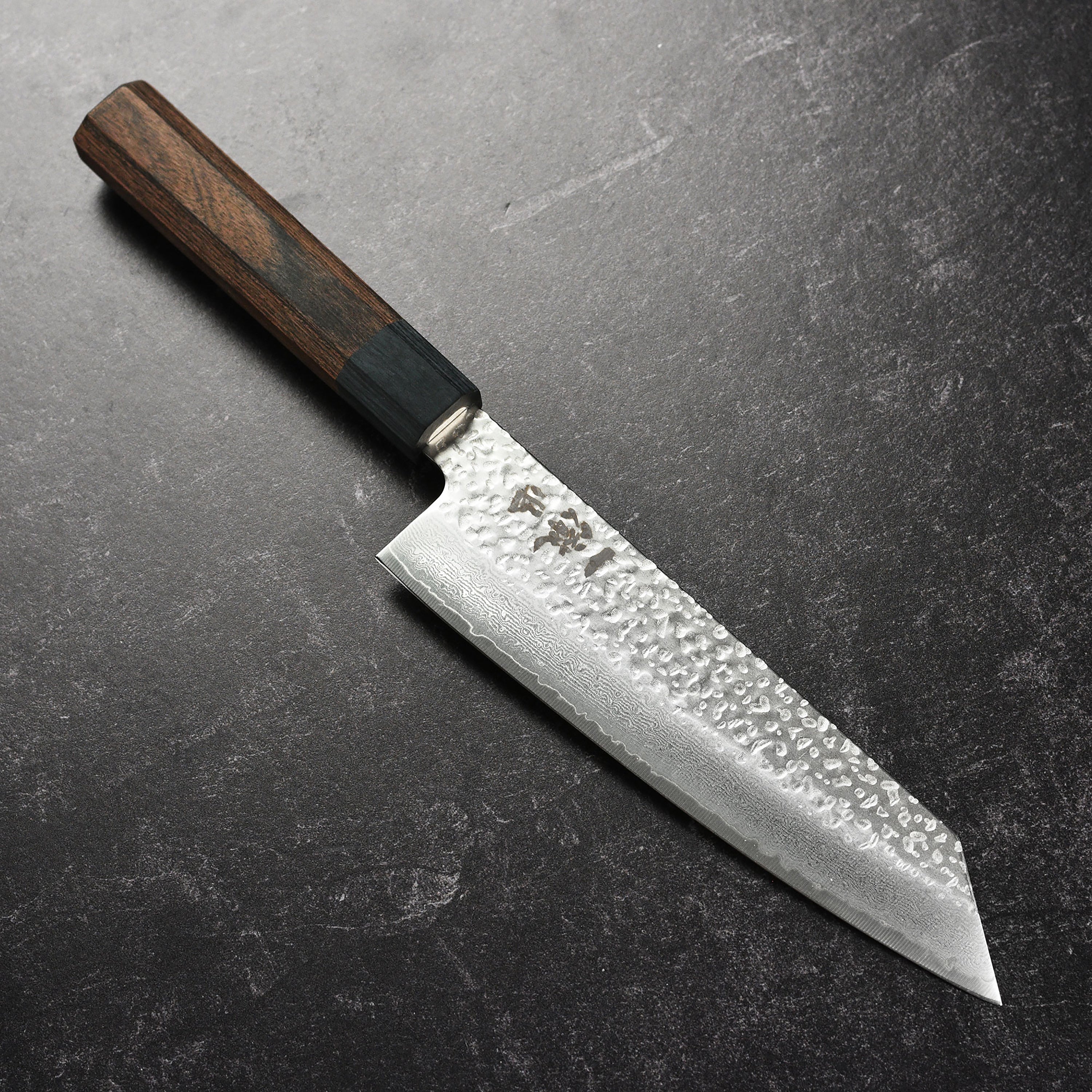Ittetsu VG10 Bunka Knife displaying the intricate hammered pattern and sharp edge, ideal for chefs.