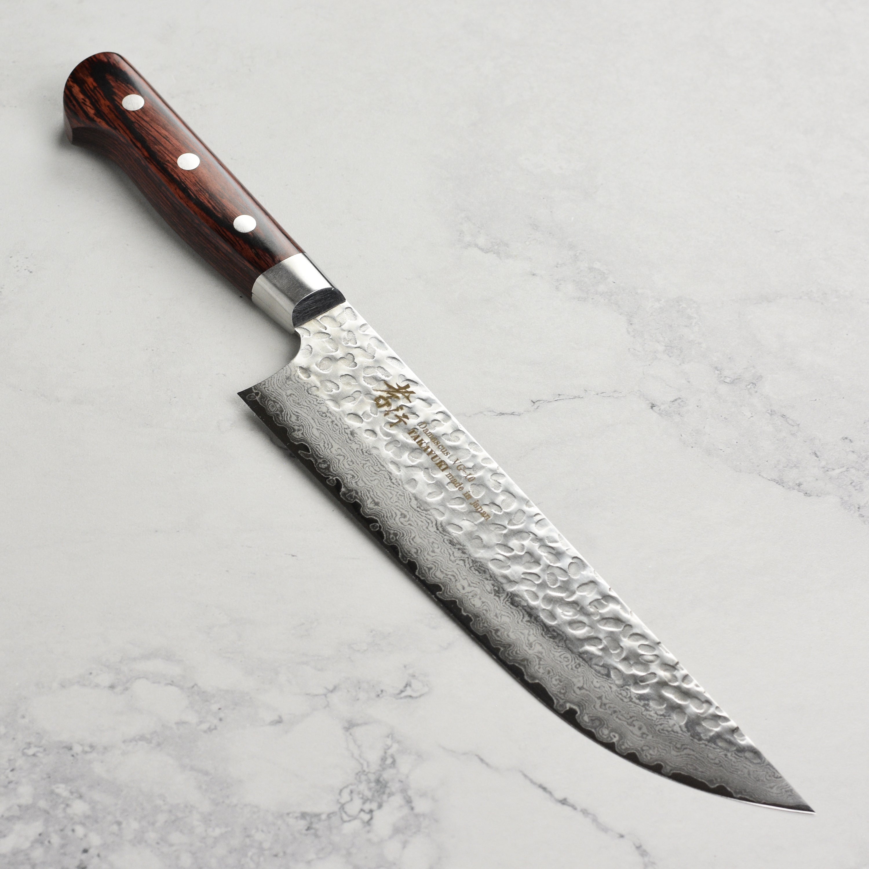 Sakai Artisan Hammered Damascus Kitchen Butcher Knife showcasing the 33-layer blade and elegant handle.
