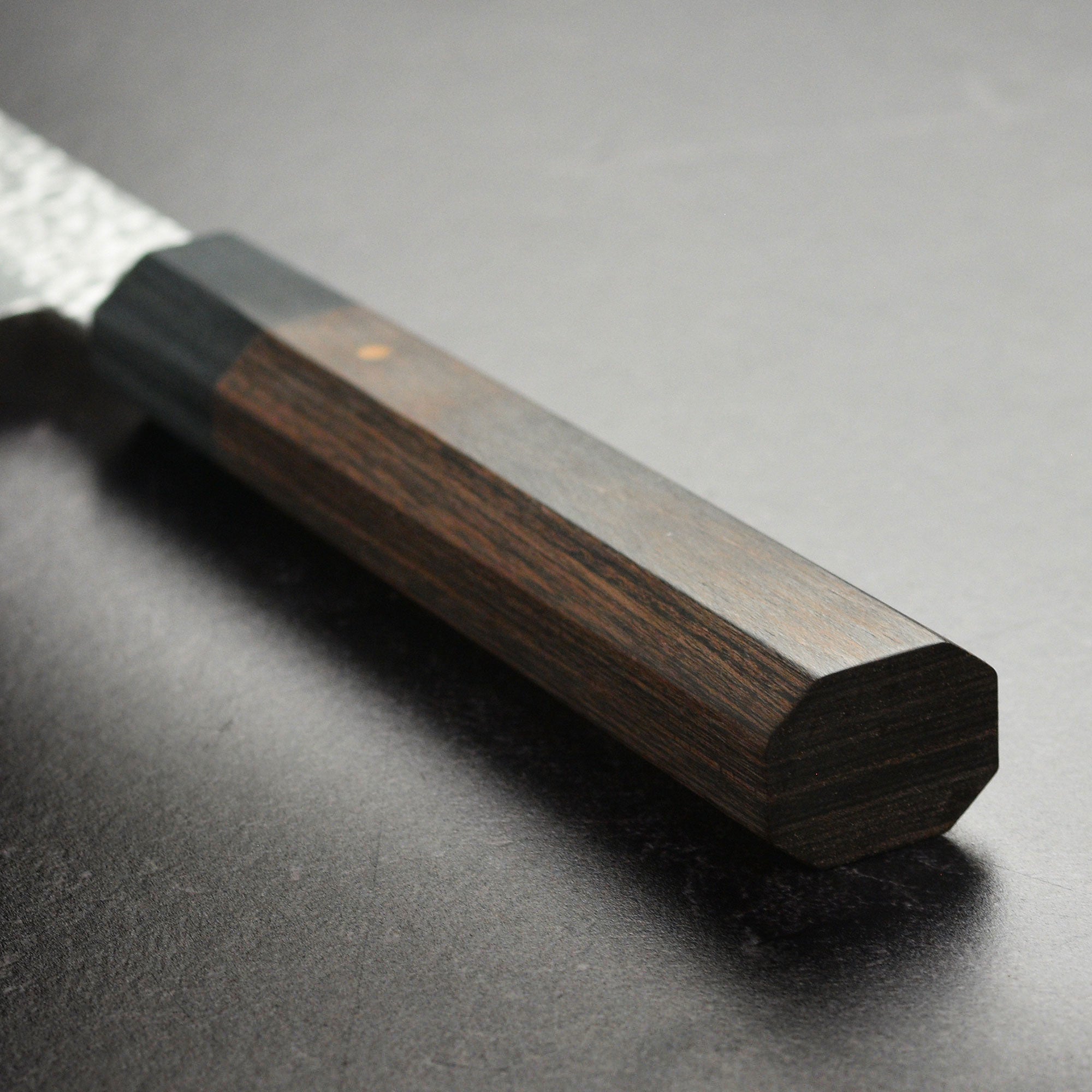Ittetsu VG10 petty knife in action, slicing fresh vegetables on a wooden cutting board.