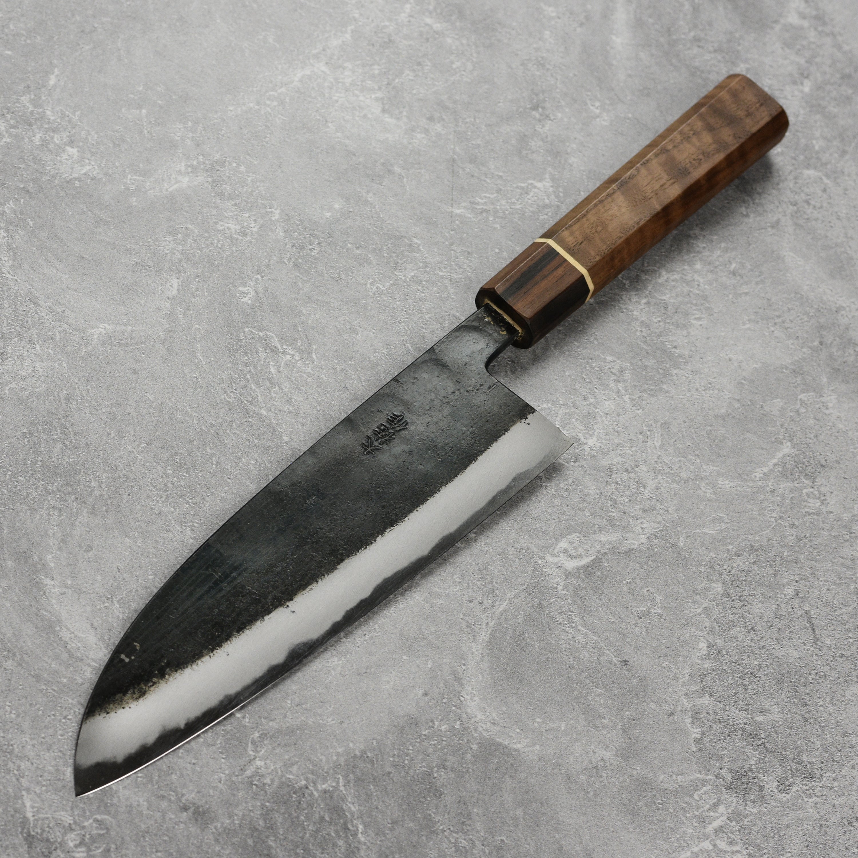 Nishida Shirogami Funayuki Gyuto Knife showcasing its sharp blade and walnut handle from a side angle.