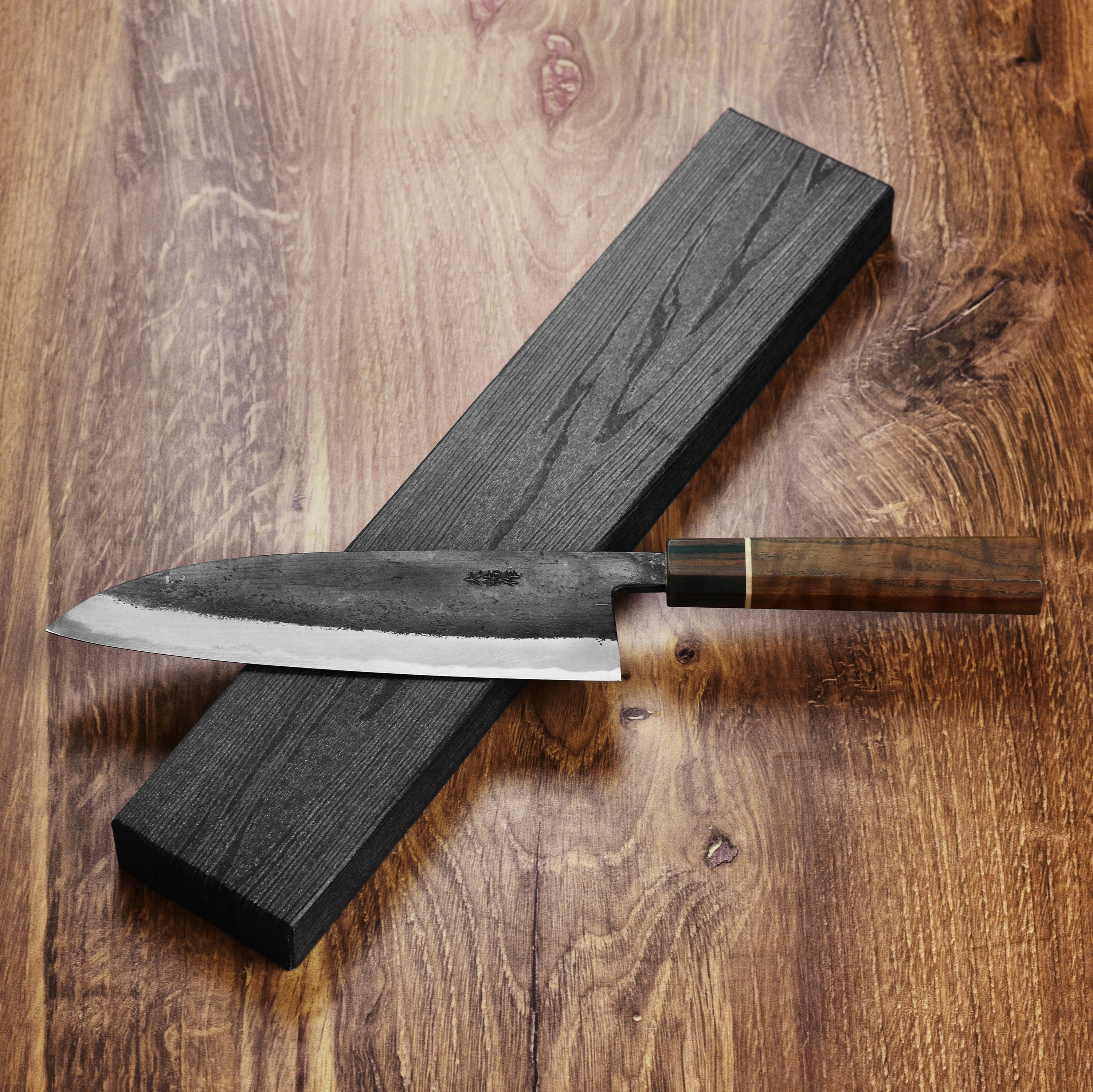 Nishida Shirogami Funayuki Gyuto Knife in use, slicing fresh vegetables on a wooden cutting board.