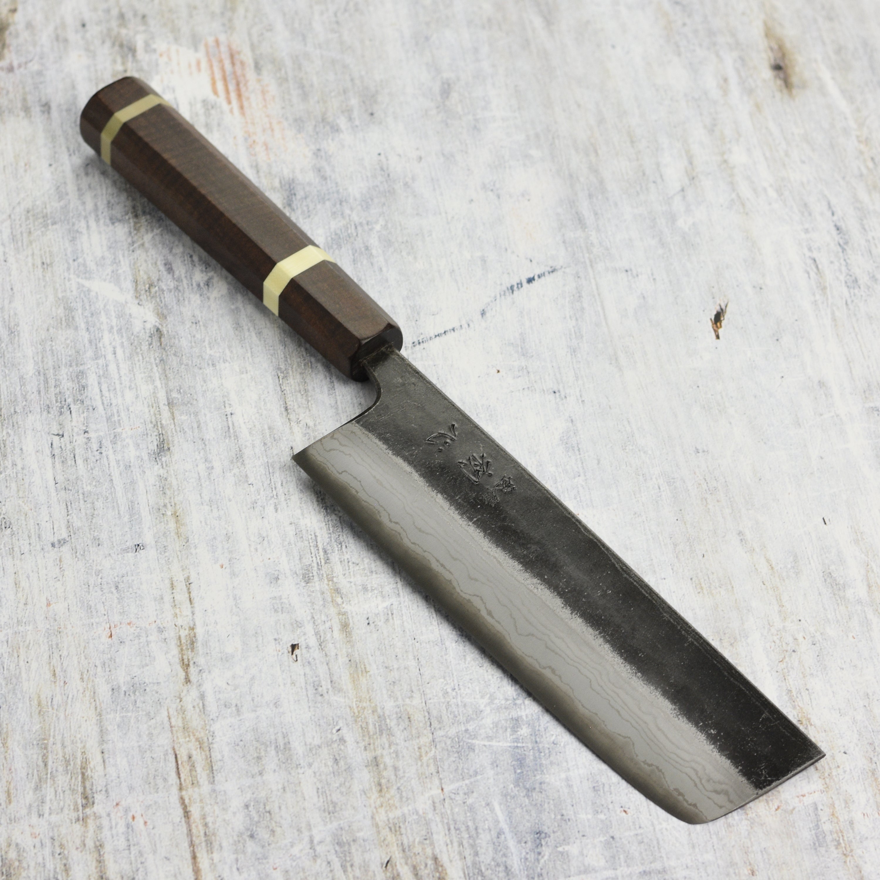 Hatsukokoro Kumokage Nakiri Knife with a sharp blade and custom handle, perfect for vegetable preparation.