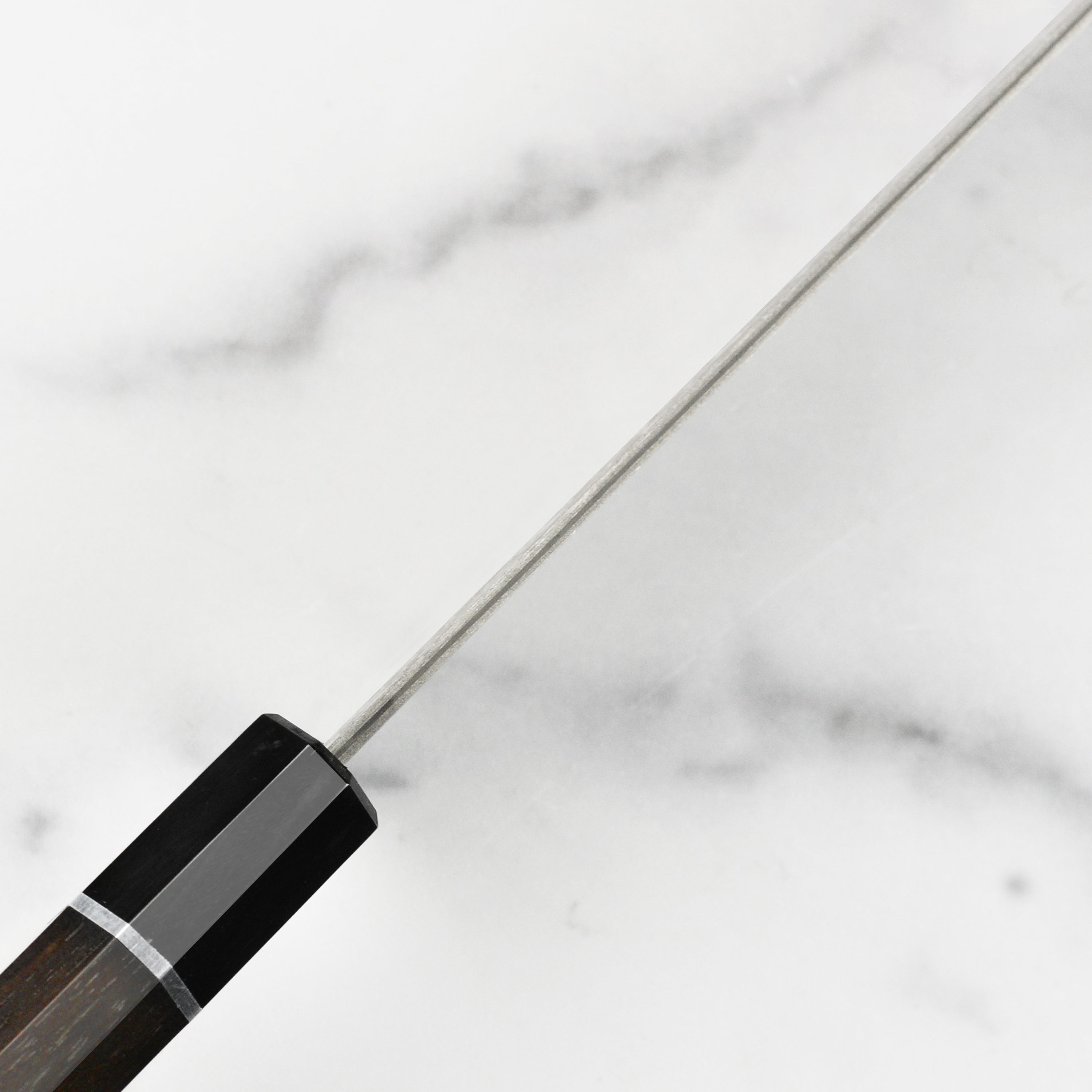 Saji Gyuto knife in its elegant wooden gift box, highlighting the craftsmanship and presentation.