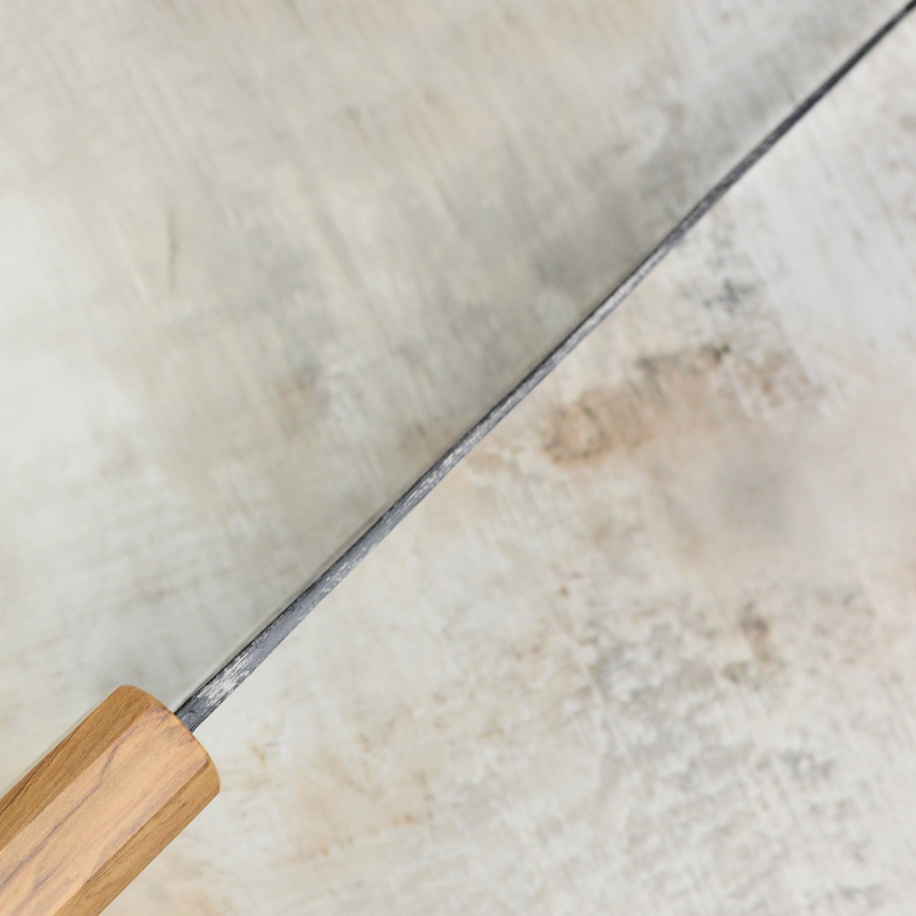 The bunka knife in action, slicing through fresh vegetables, demonstrating its precision and sharpness.