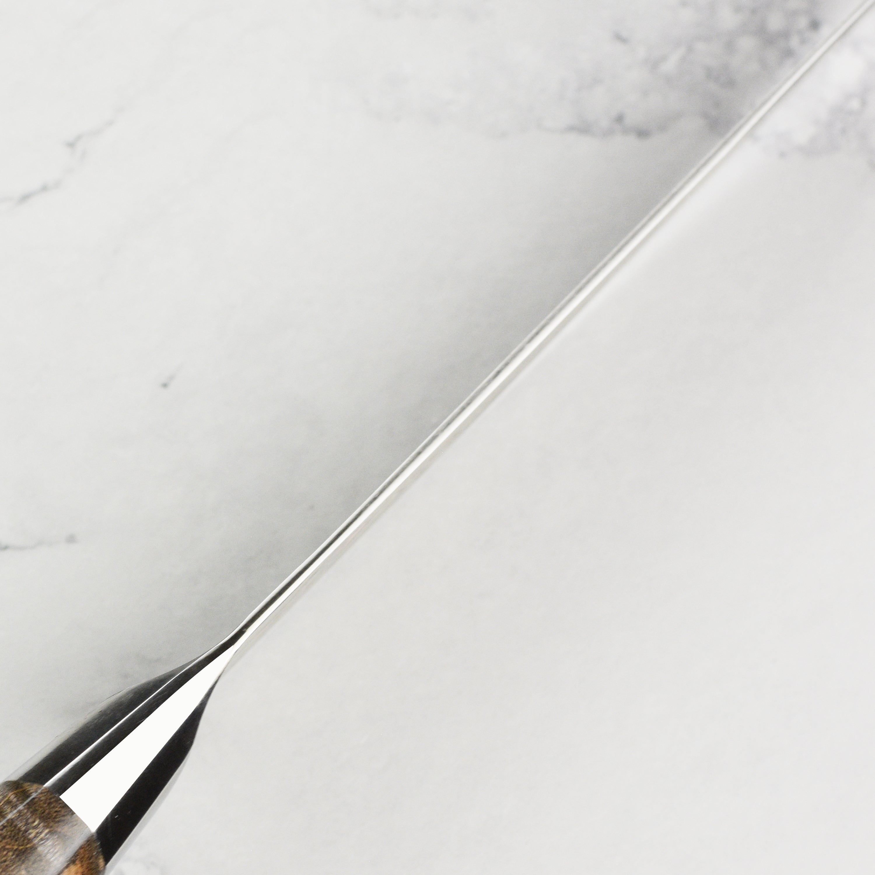 Close-up of Miyabi Iki Damascus pattern on high-carbon chefs knife