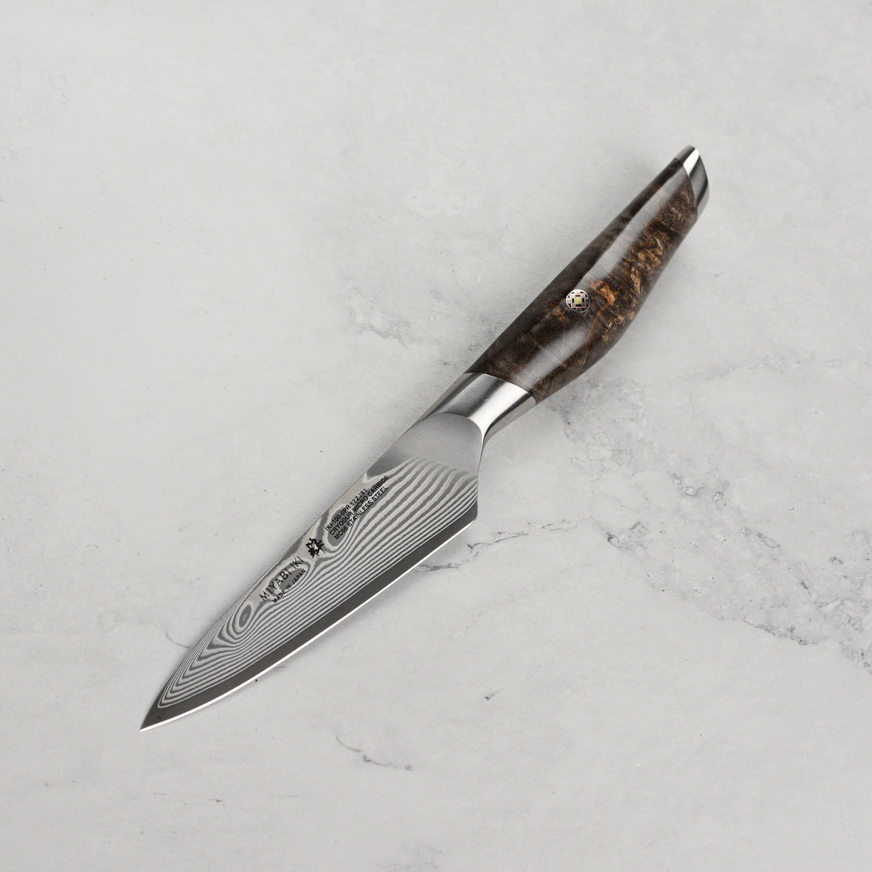 Detailed view of the Miyabi Iki 3.5-inch paring knife in a professional kitchen setting