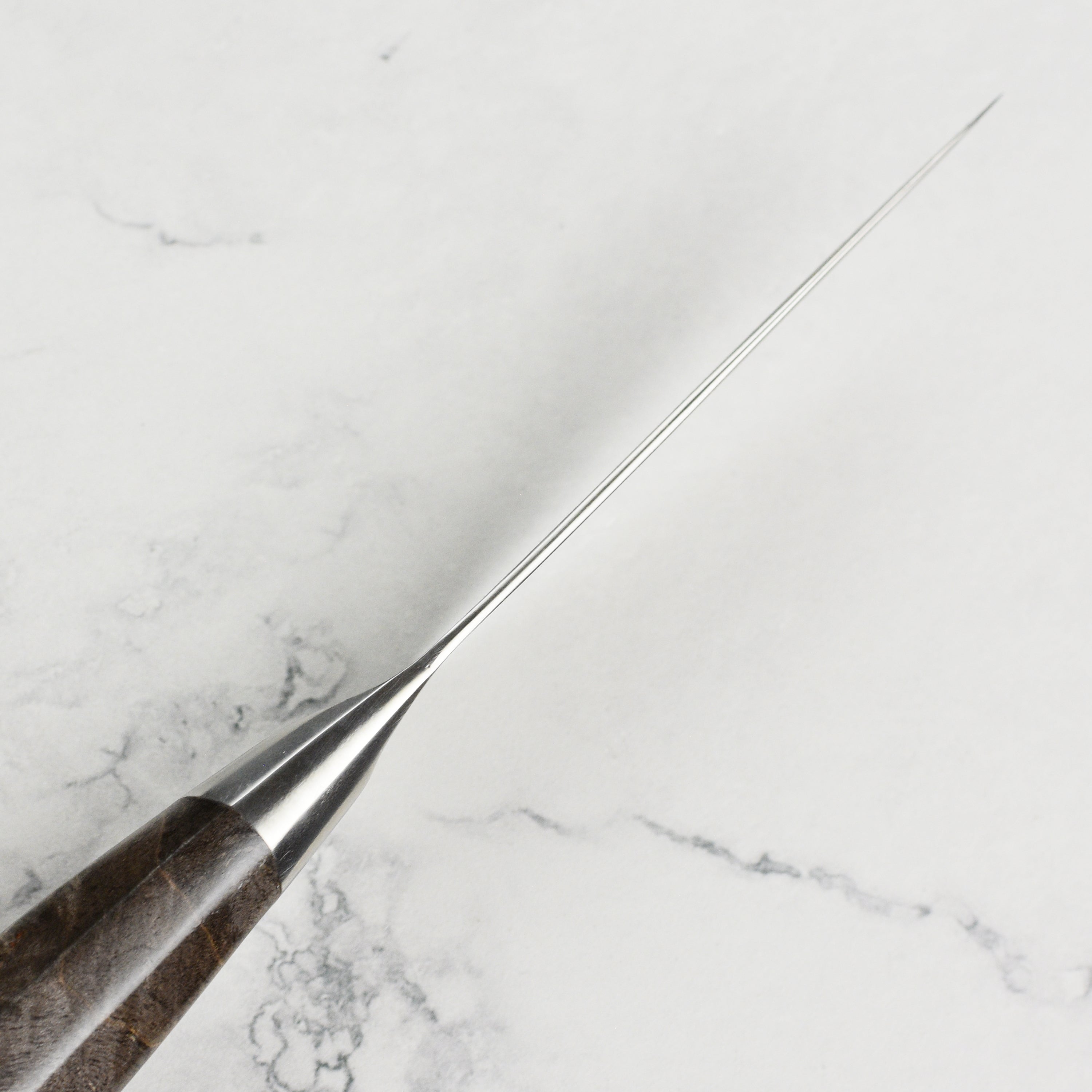 Detailed view of the Miyabi Iki 3.5-inch paring knife in a professional kitchen setting